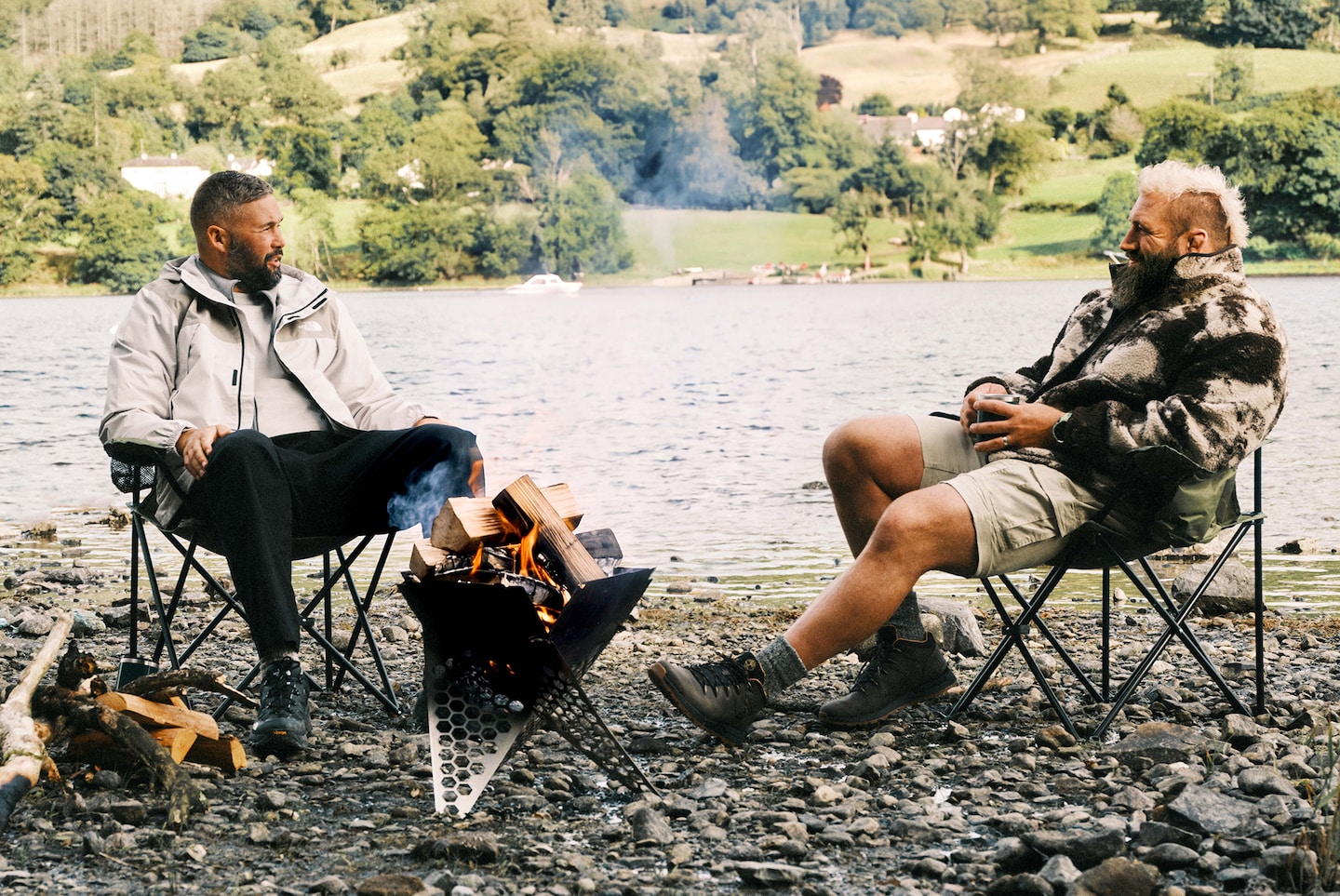Joe Marler and Tony Bellew chat by the camp fire. Joe wears Only & Sons Sherpa Jacket - Coffee Bean and Tony The North Face Antora Jacket