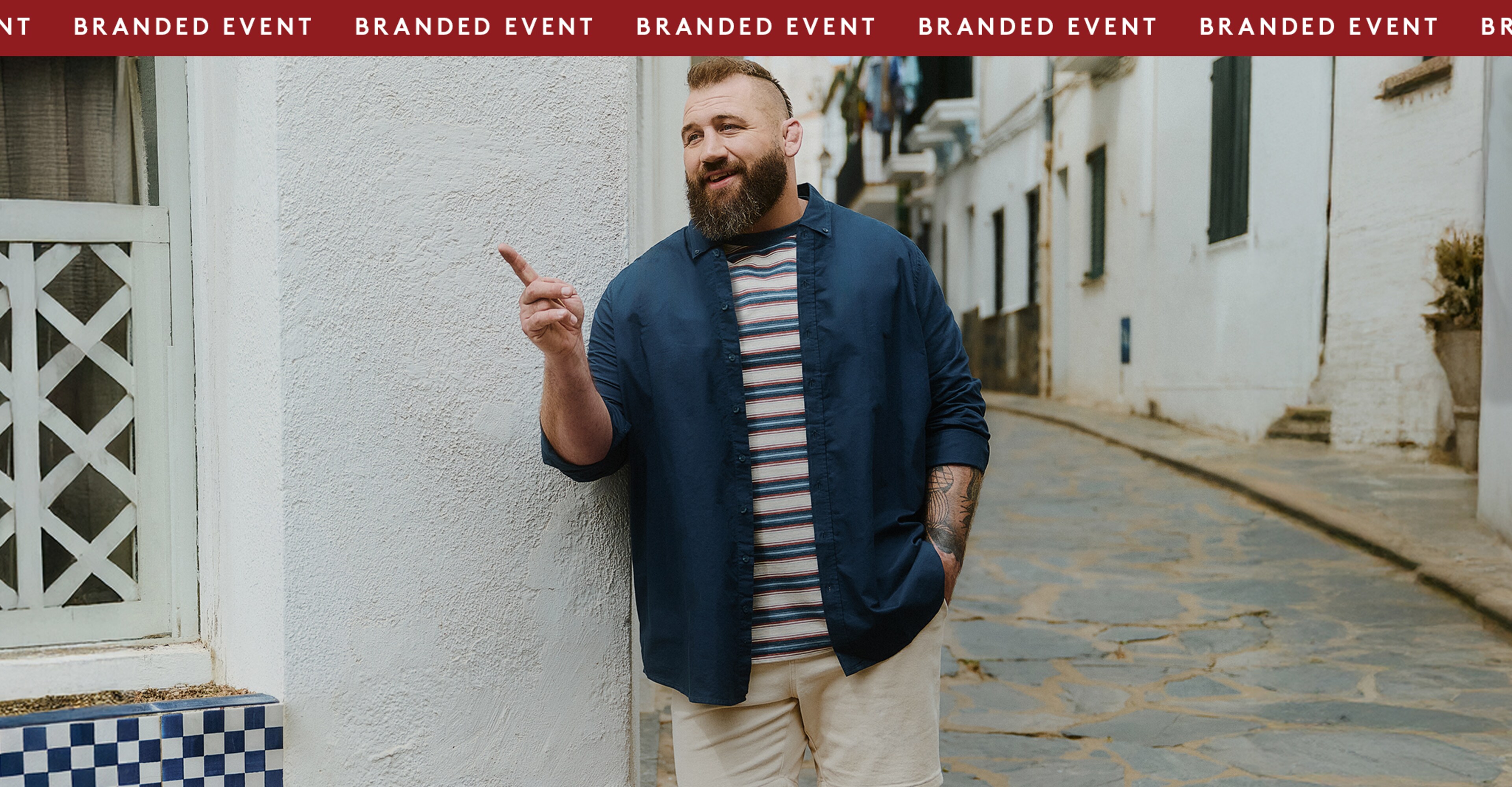 The Big Brand Bank Holiday Event up to 50% OFF* Joe Marler wears Union Relaxed Fit Marl Yarn Dye Stripe T-Shirt Long with Navy shirt and cream shorts