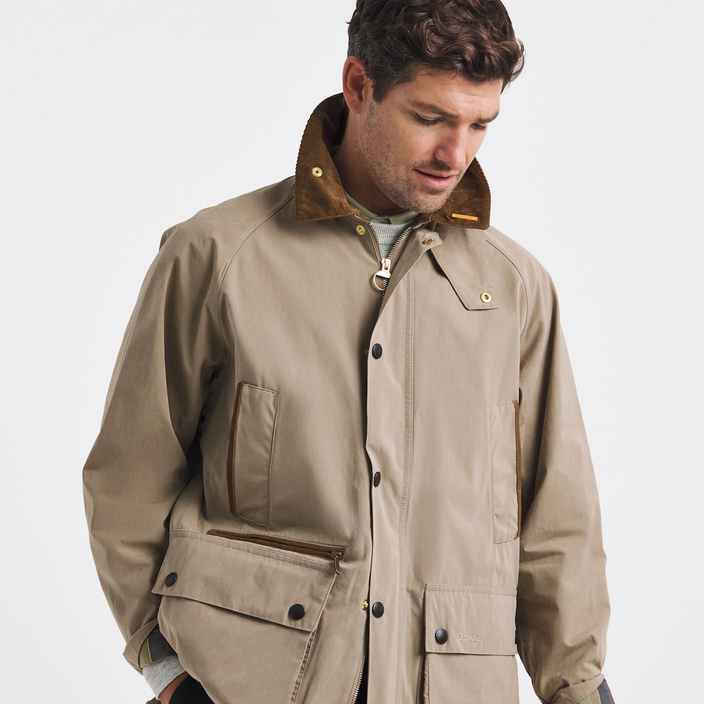 Model is wearing a military brown Barbour Icons Bedale casual jacket.