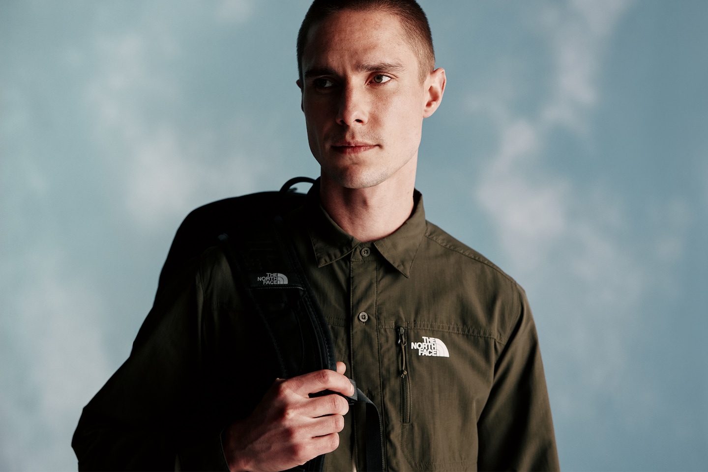 Model wears Olive overshirt and backpack from The North Face