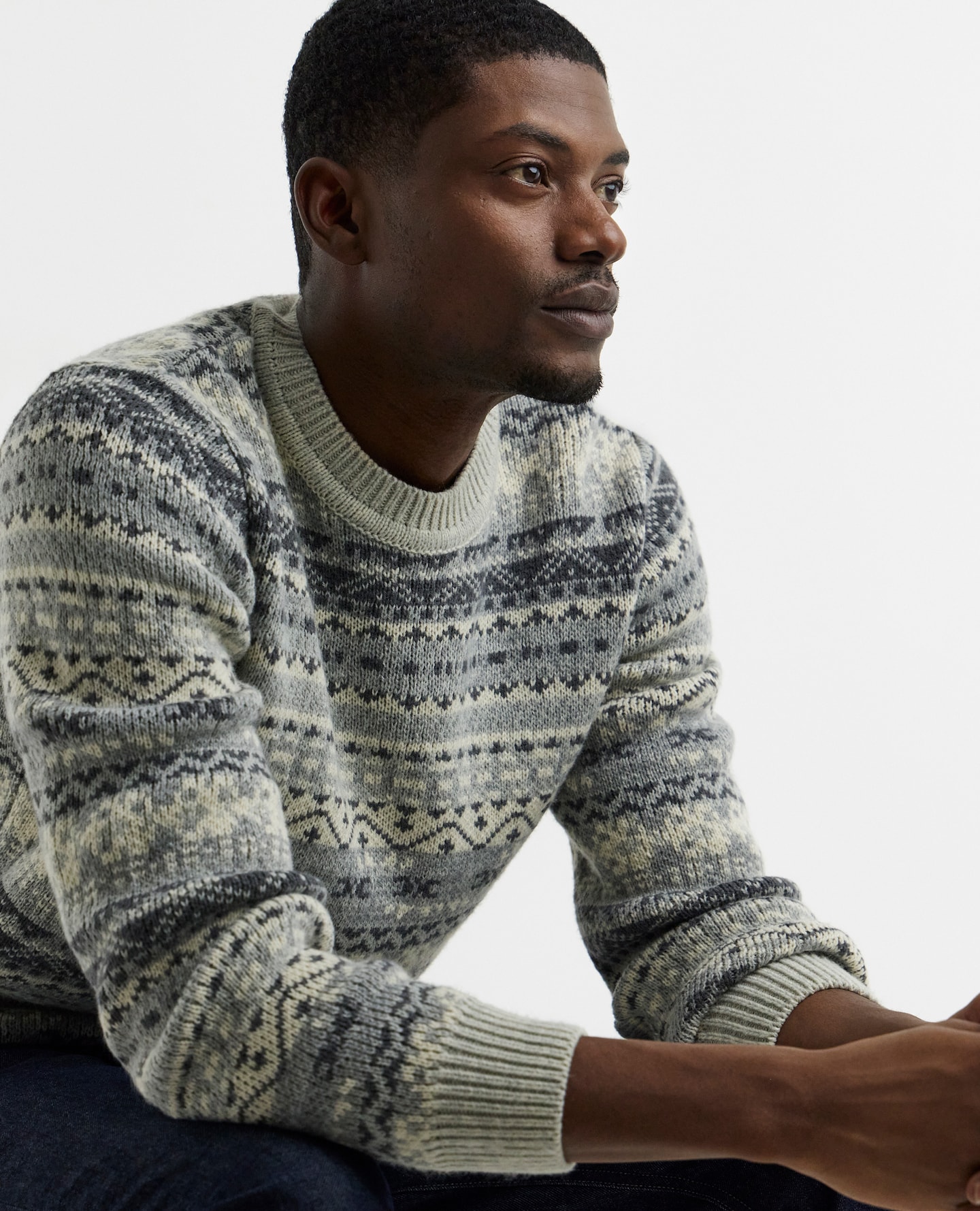 Model wears Knitted Fairisle Crew Neck Jumper in Grey