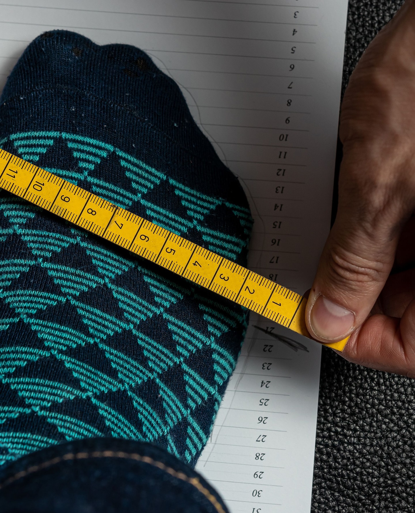 Close up on a foot being measured across the width