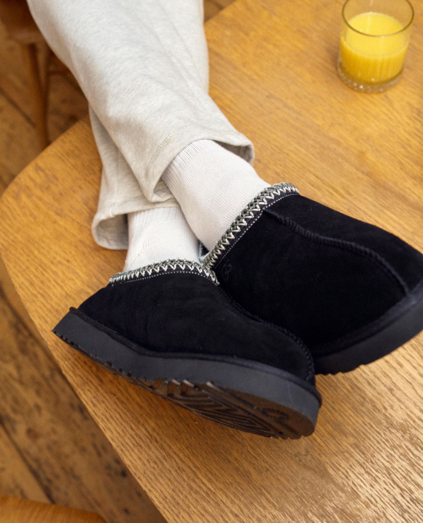 Model wears black Ugg slippers and loungewear