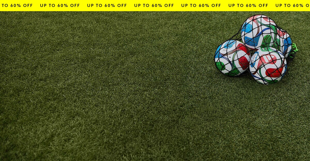 Up to 60% off Summer Essentials. World Cup footballs are pictured on a field