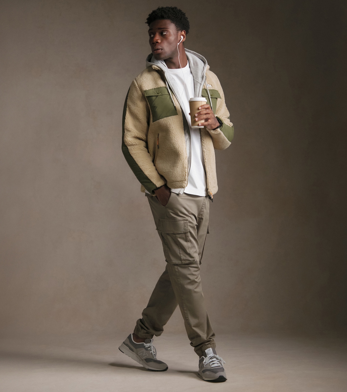 Man wearing a a full zip fleece and beige cargo pants