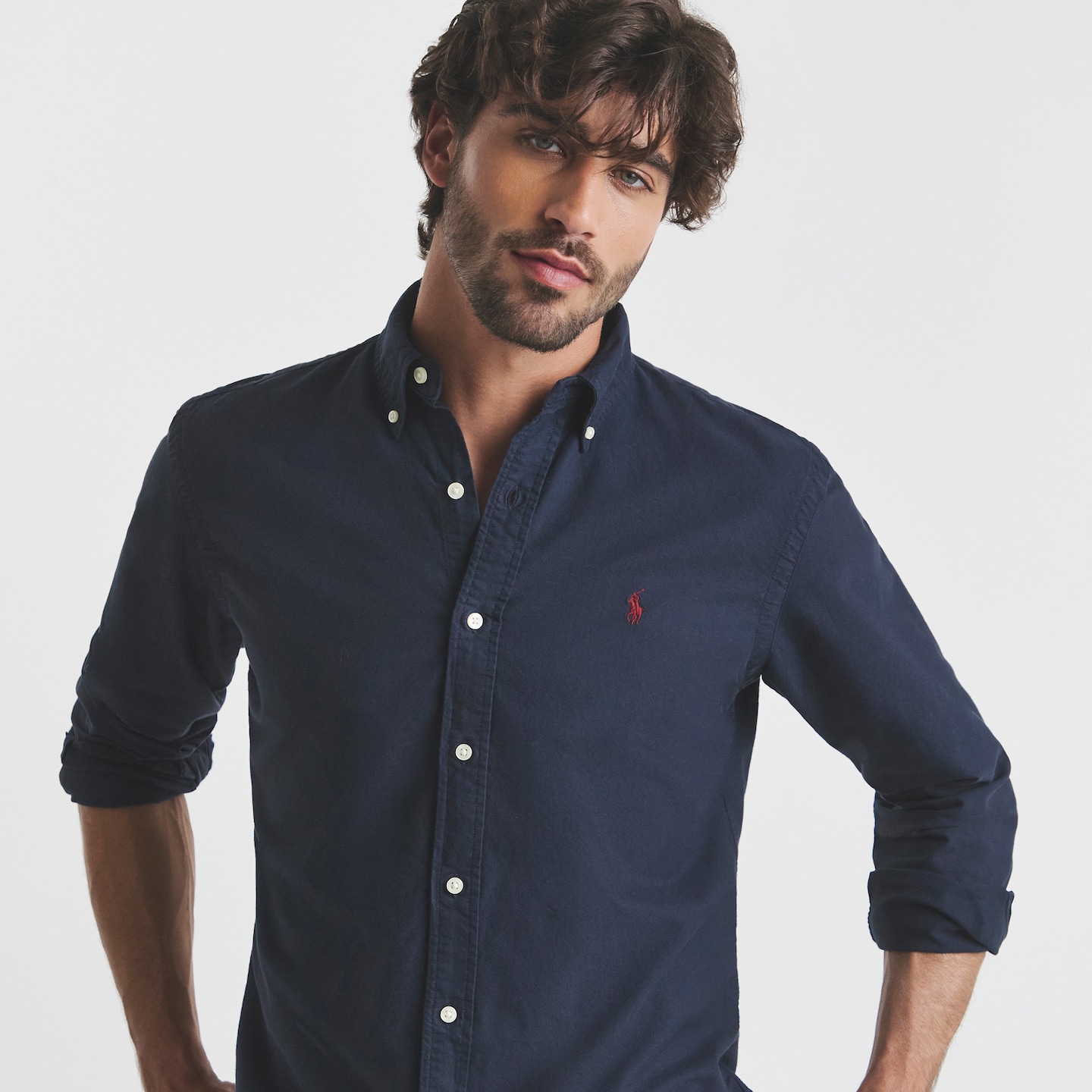 Model is wearing a navy Polo Ralph Lauren long sleeve shirt.