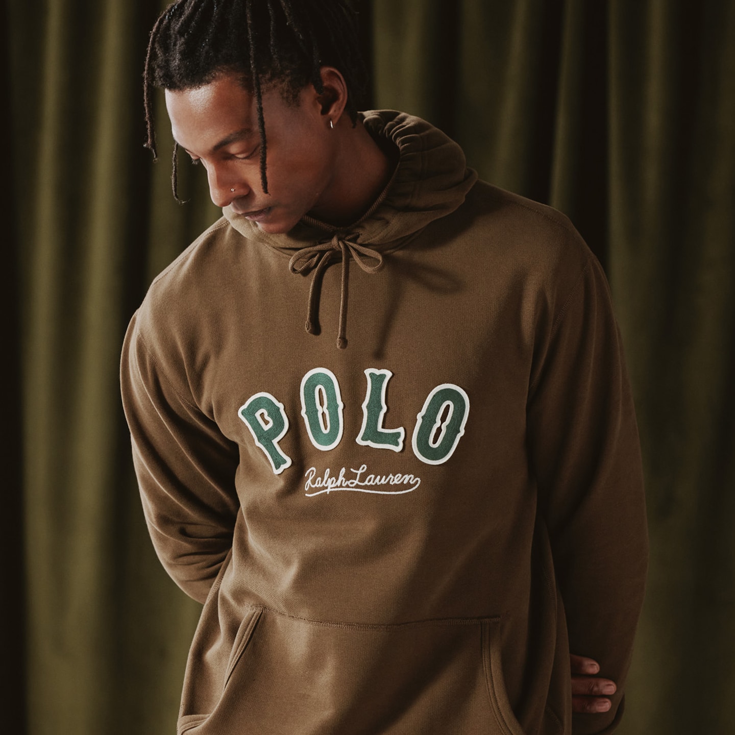 Model is wearing a brown Polo Ralph Lauren logo hoodie.