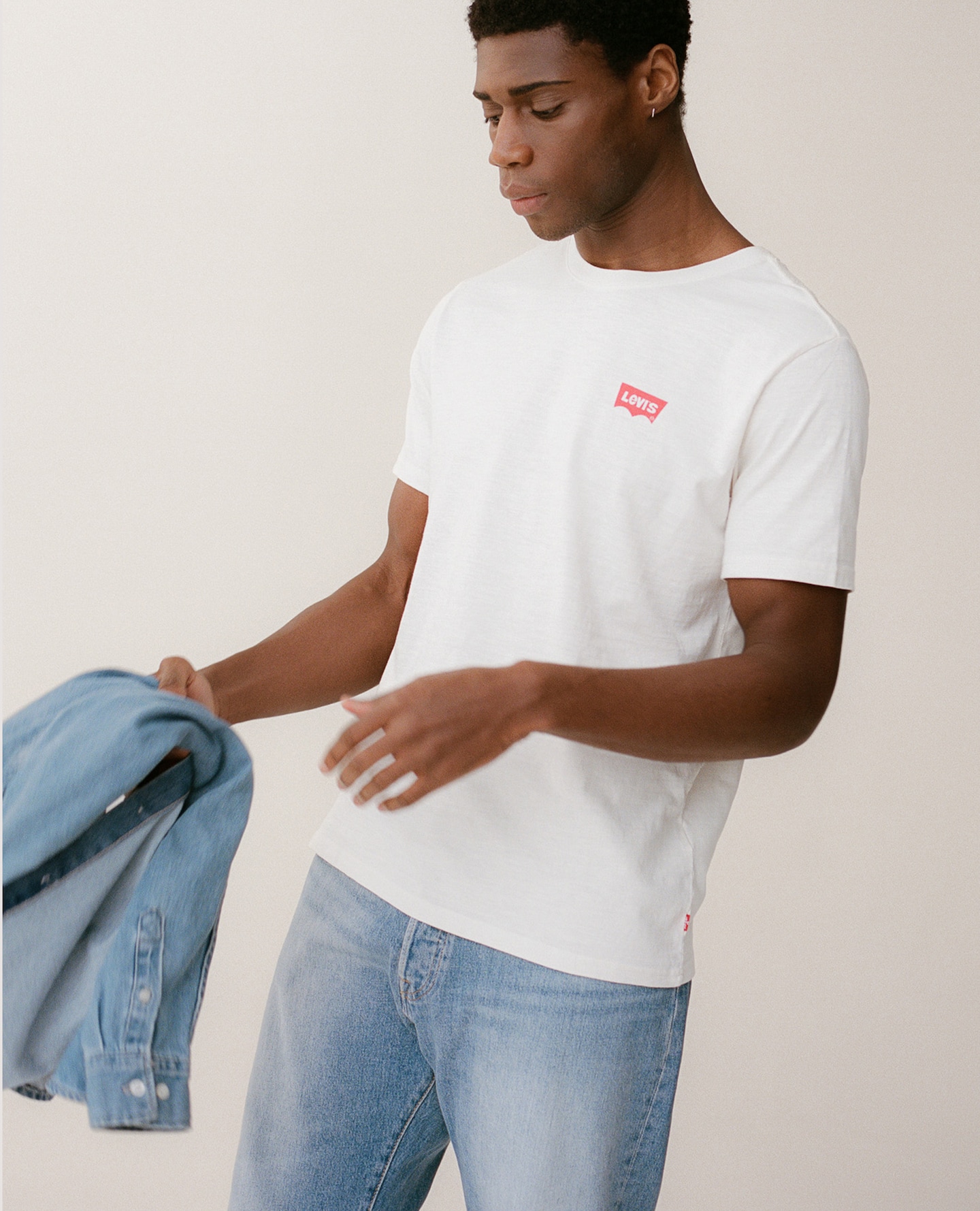 Model wears Levi's Short Sleeve Housemark T-Shirt - White with Levi's 501 Original Straight Fit Jean and Levi's Classic Western Denim Shirt - Stonewash