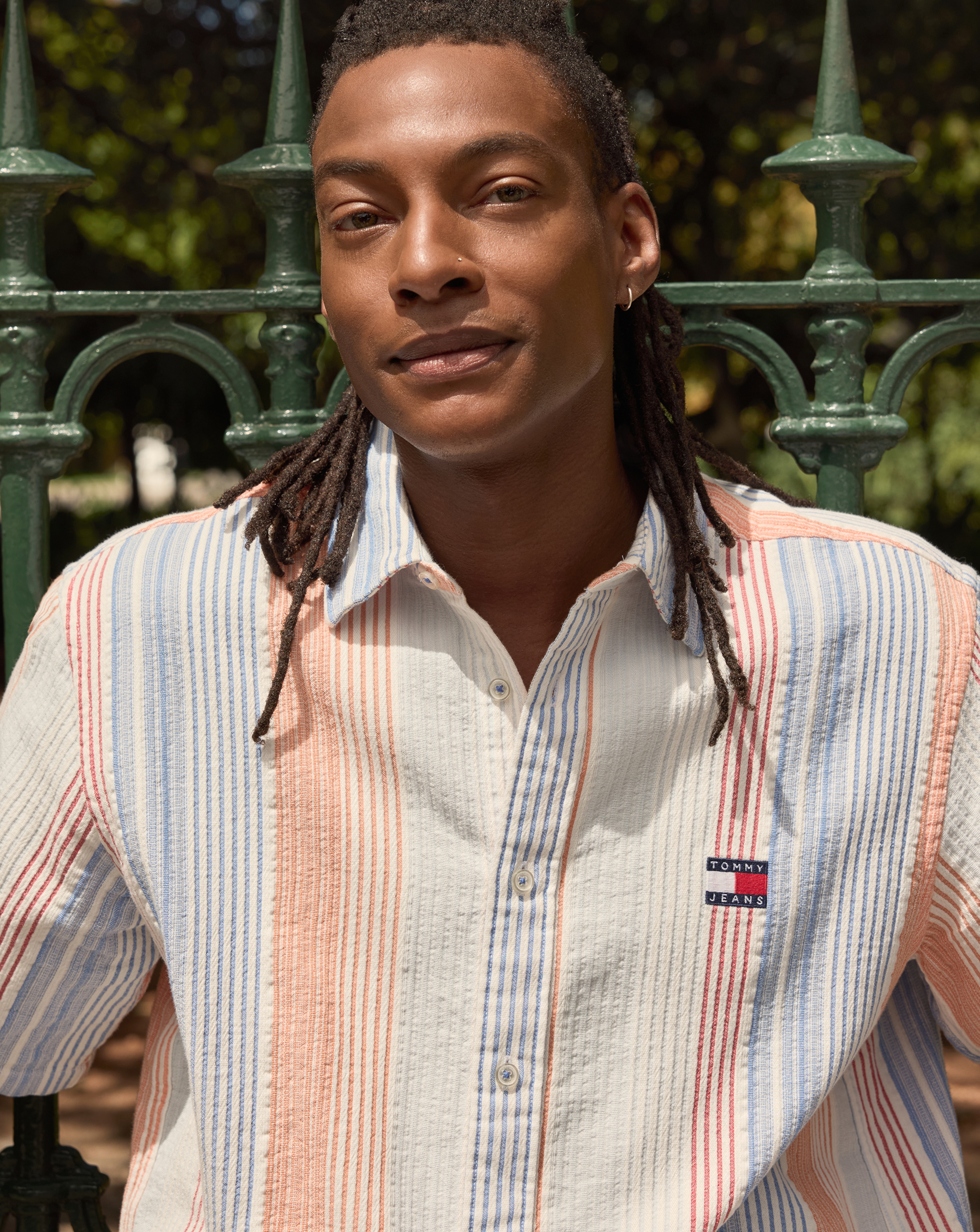 Model wears Tommy Jeans Short Sleeve Relax Stripe Short Sleeve Shirt - White