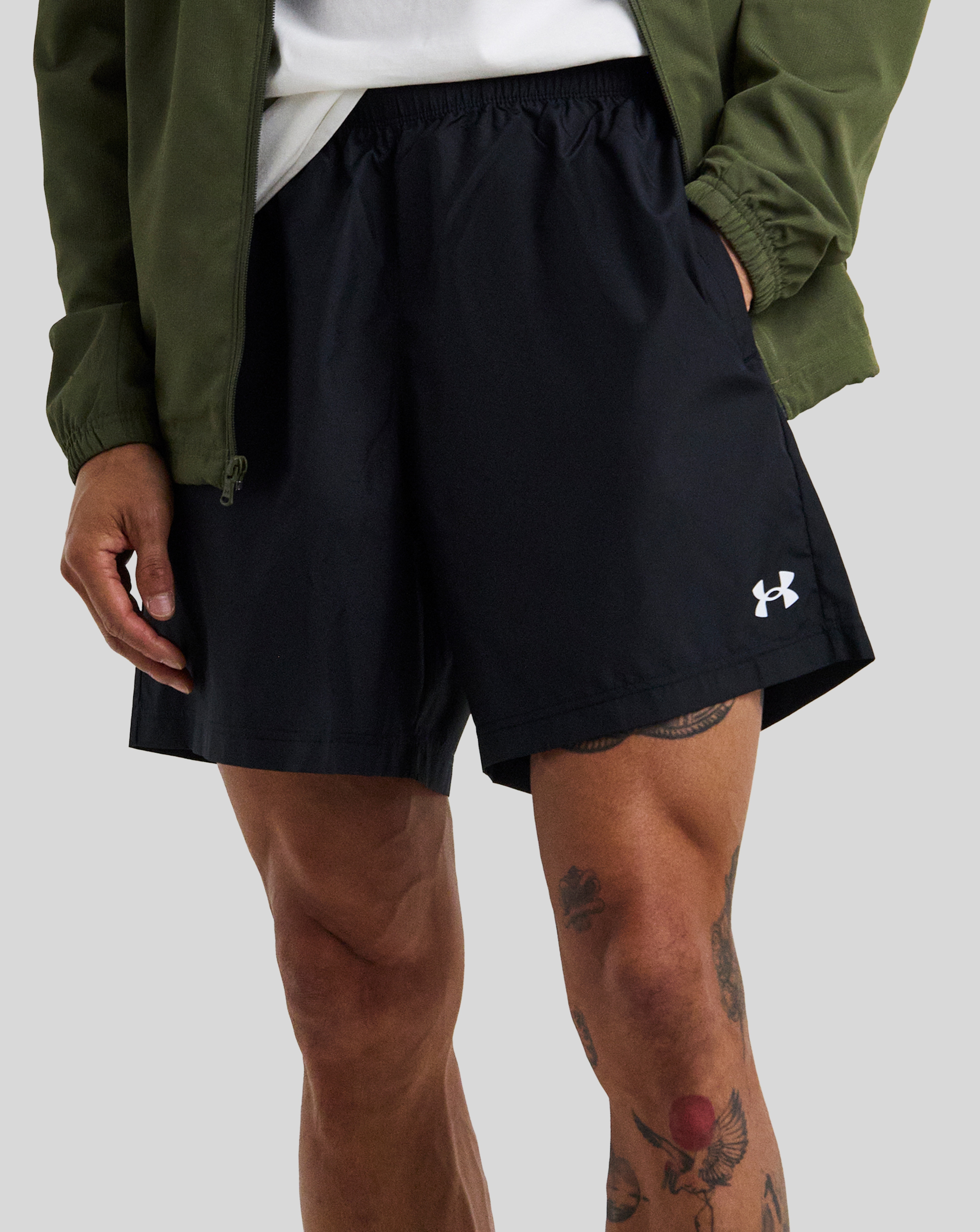 Model wears Under Armour Tech Woven 7 Inch Short in Black