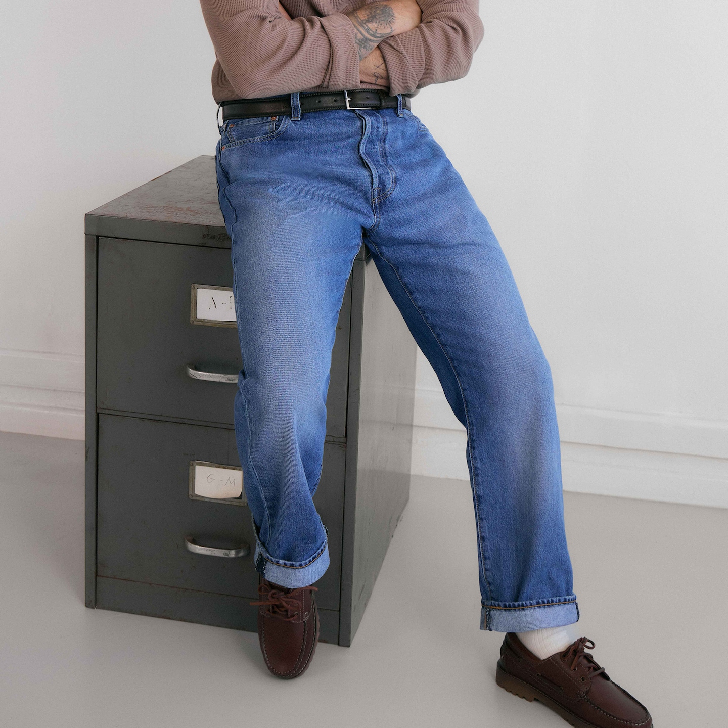 Model is wearing a pair of Levi's 501 Original Straight Fit Jeans.