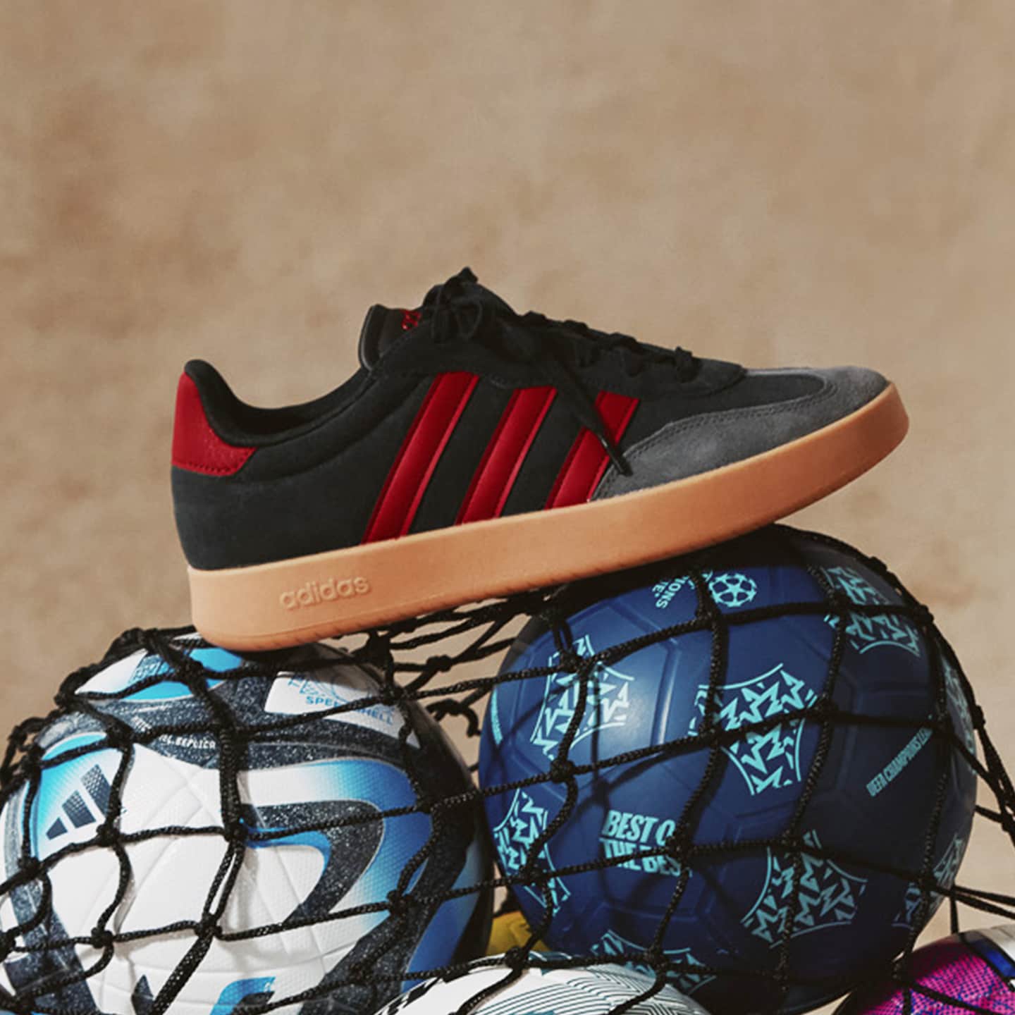 adidas VL Court 3.0 Trainers on top of footballs.