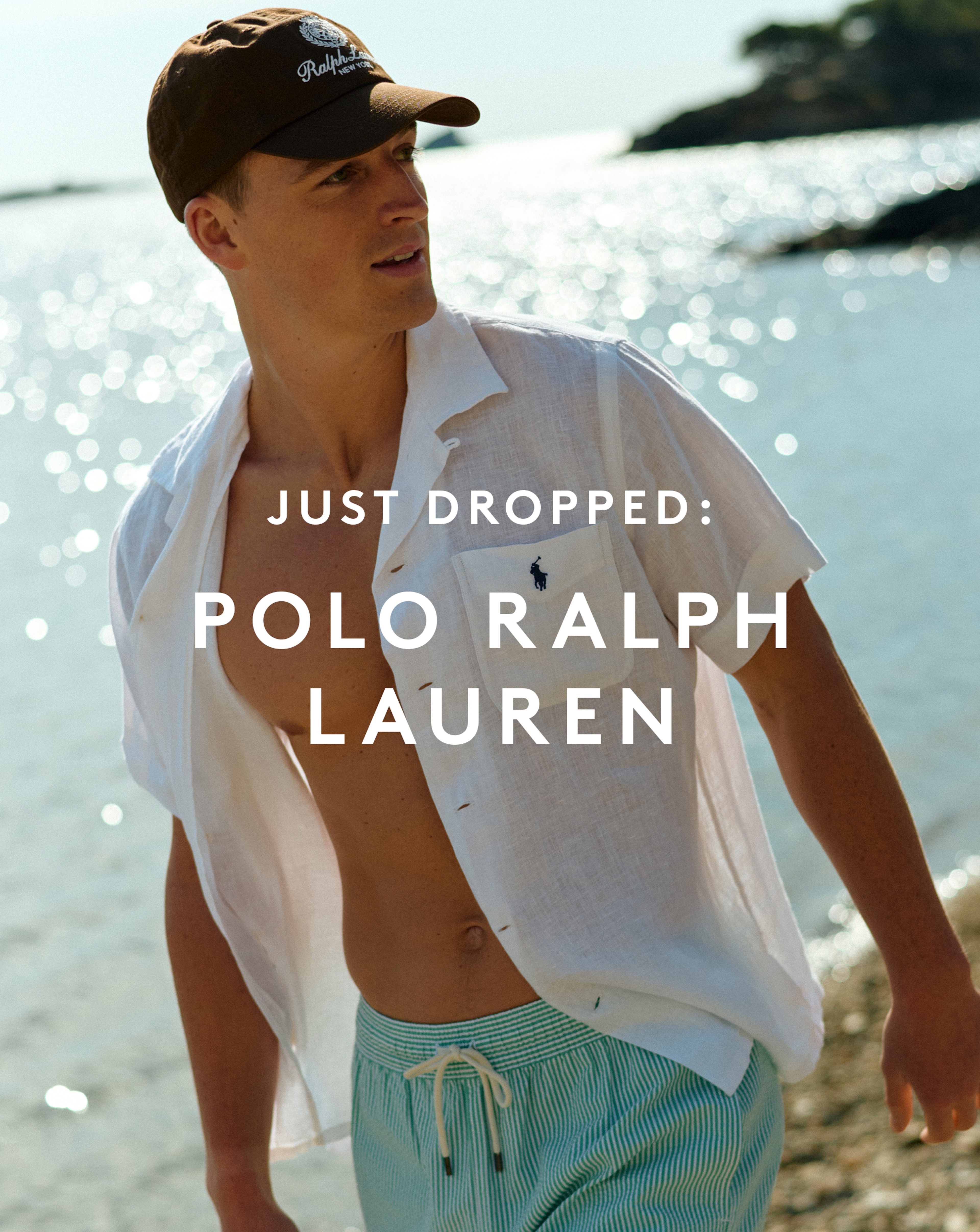 Just dropped: Polo Ralph Lauren. Model wears Polo Ralph Lauren Short Sleeve Linen Resort Shirt - White with Polo Ralph Lauren Script Logo Cap - Brown