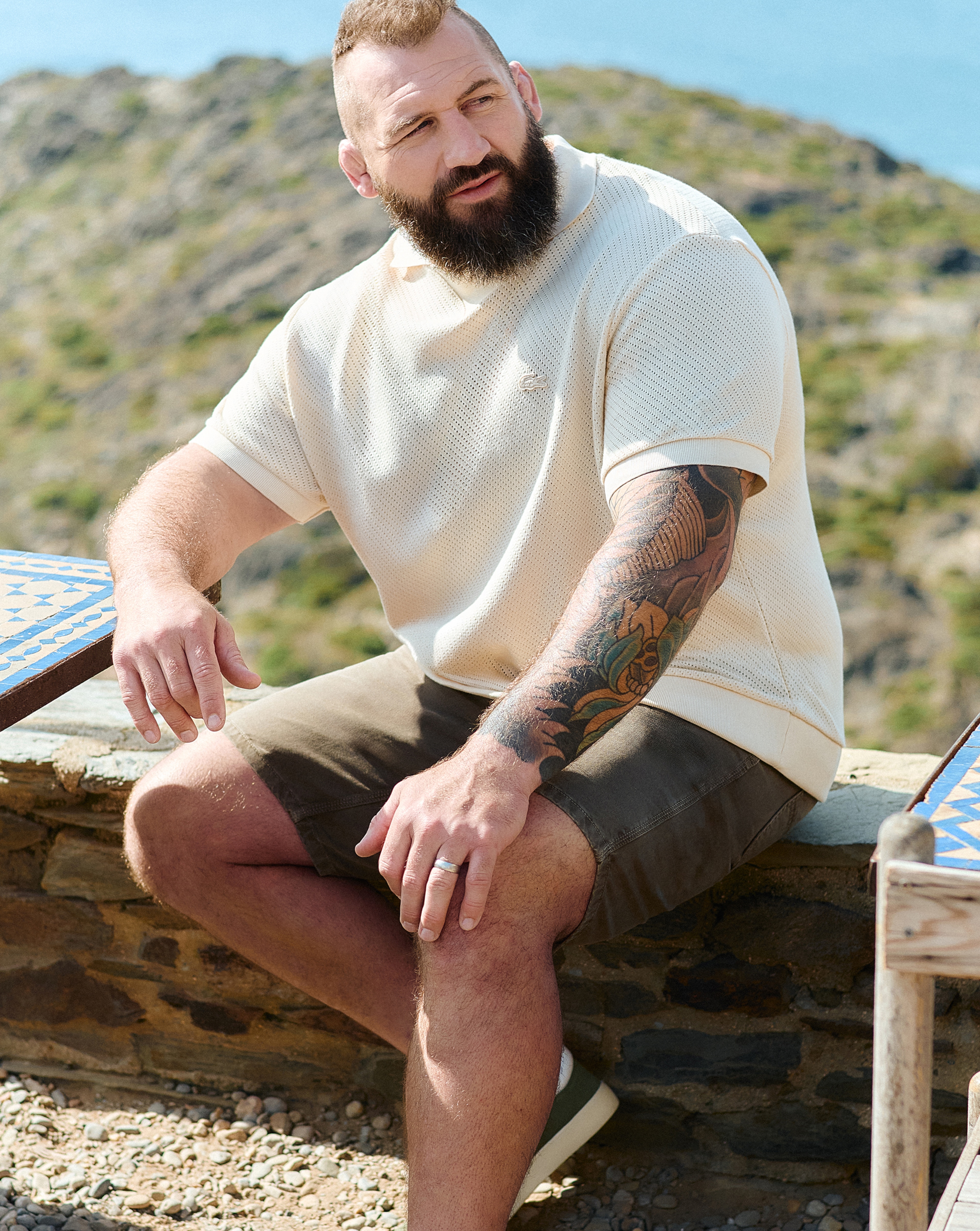 Joe Marler wears Jack & Jones Jaiden Tyson Textured Short - Green with Lacoste Short Sleeve Open Neck Textured Polo - Natural
