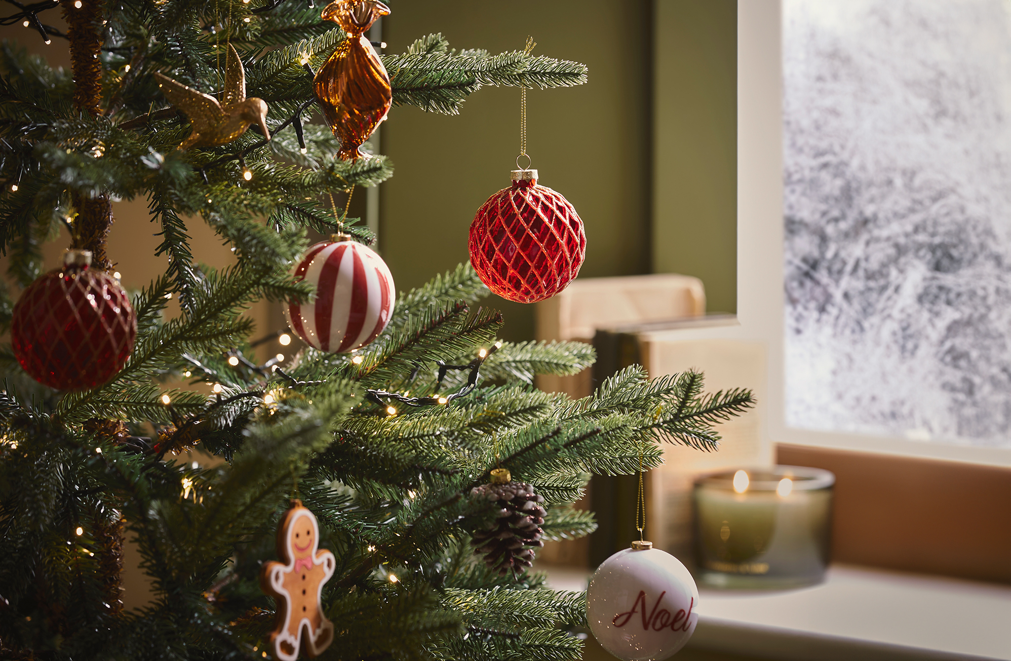 Helsinki Slim Real Look Christmas Tree is pictured with various baubles.