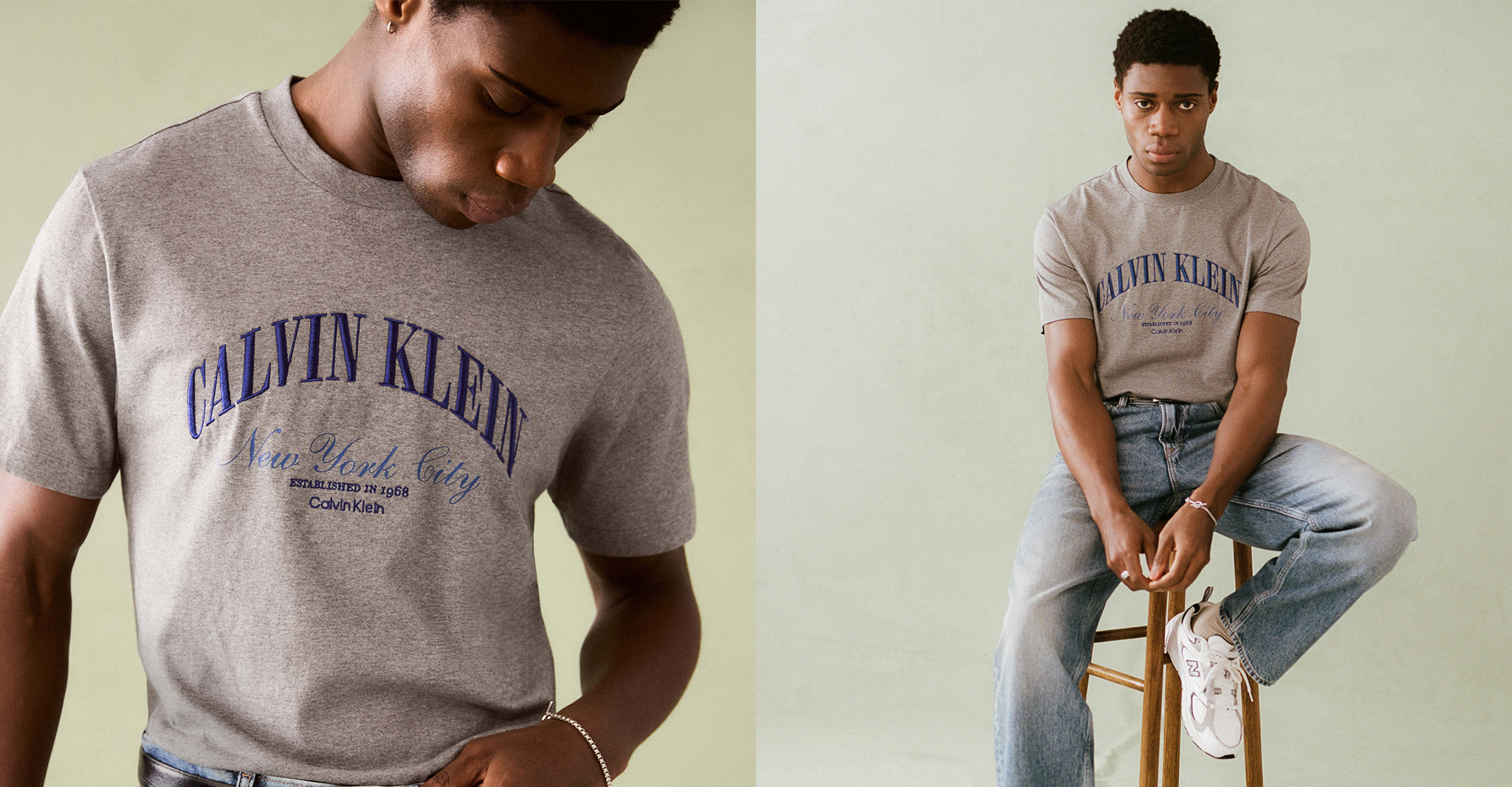 Model is wearing a gray Calvin Klein short sleeve varsity t-shirt with a pair of Calvin Klein jeans.
