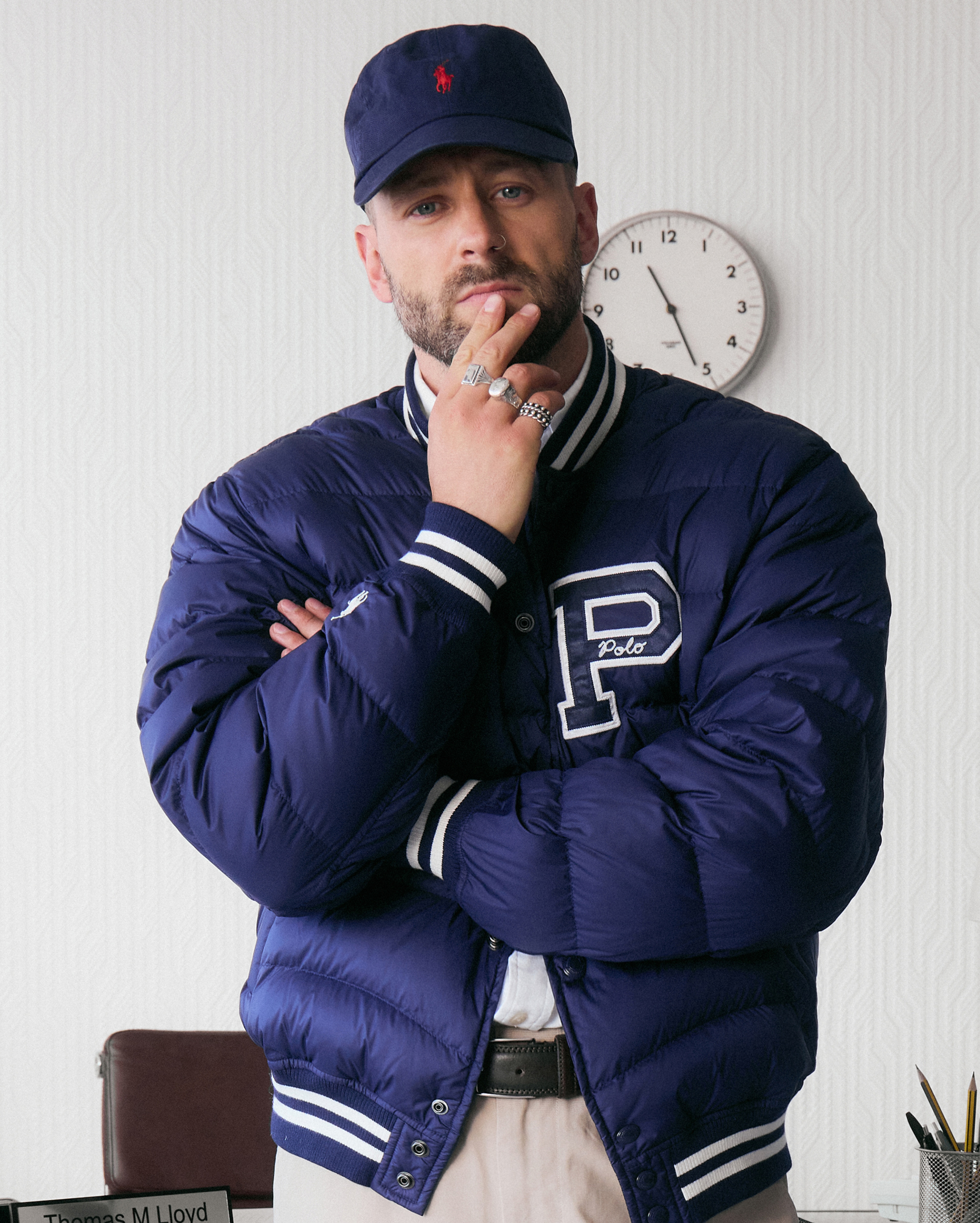 Model wears cap and varsity jacket from Polo Ralph Lauren