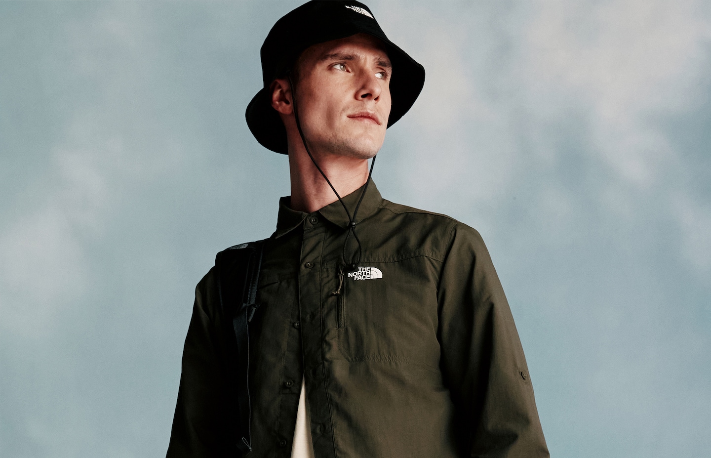 Model wears bucket hat and overshirt from The North Face