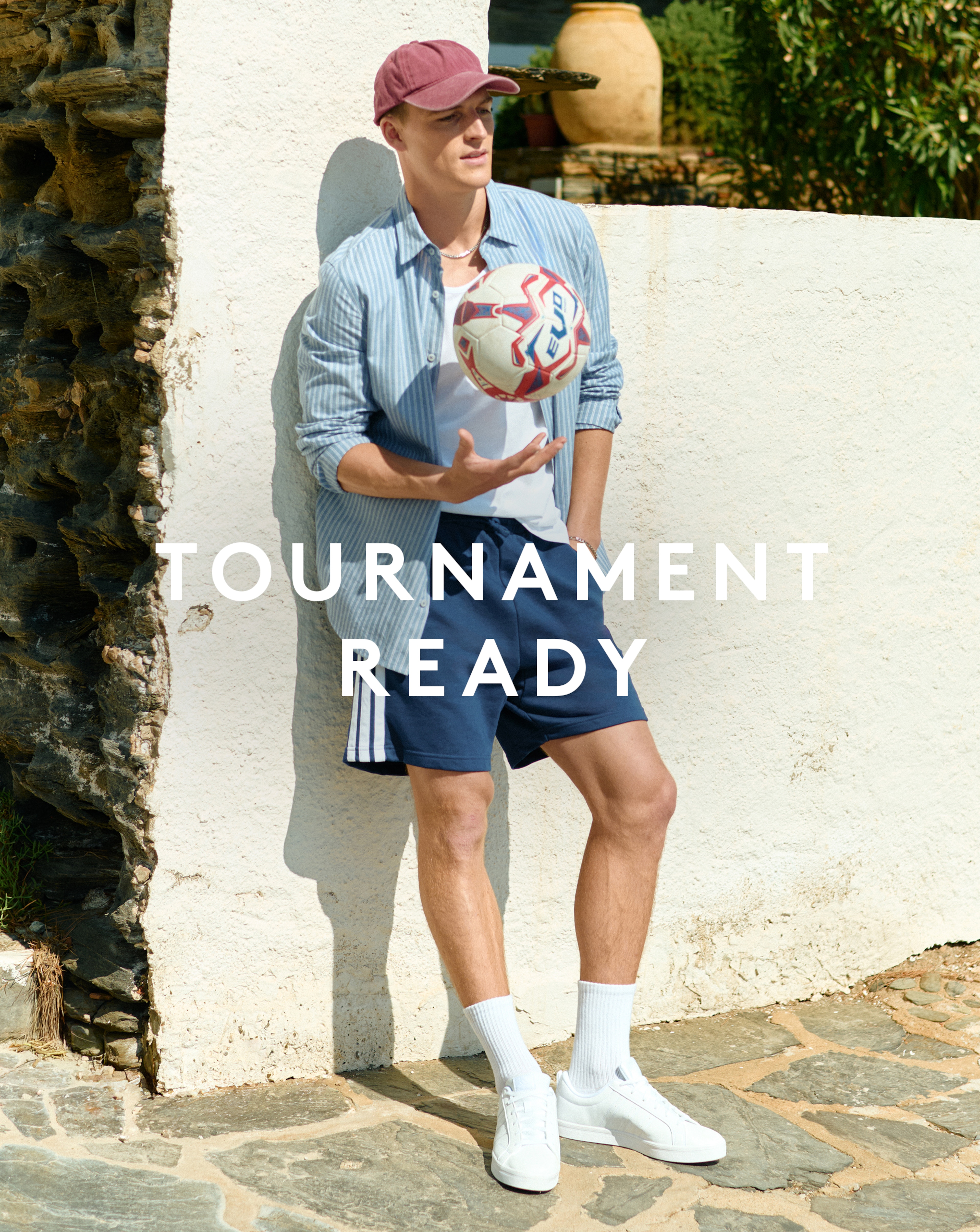 Tournament Ready. Model wears adidas 3 Stripes French Terry Shorts with blue stripe shirt and white tee