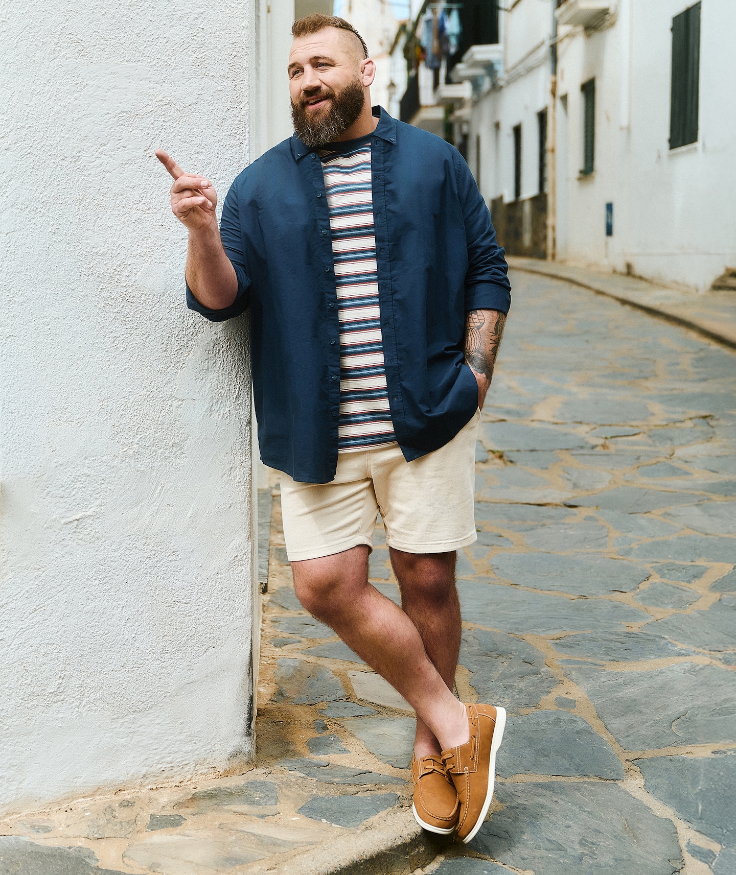 Joe Marler wears Union Relaxed Fit Marl Yarn Dye Stripe T-Shirt with blue shirt and cream shorts
