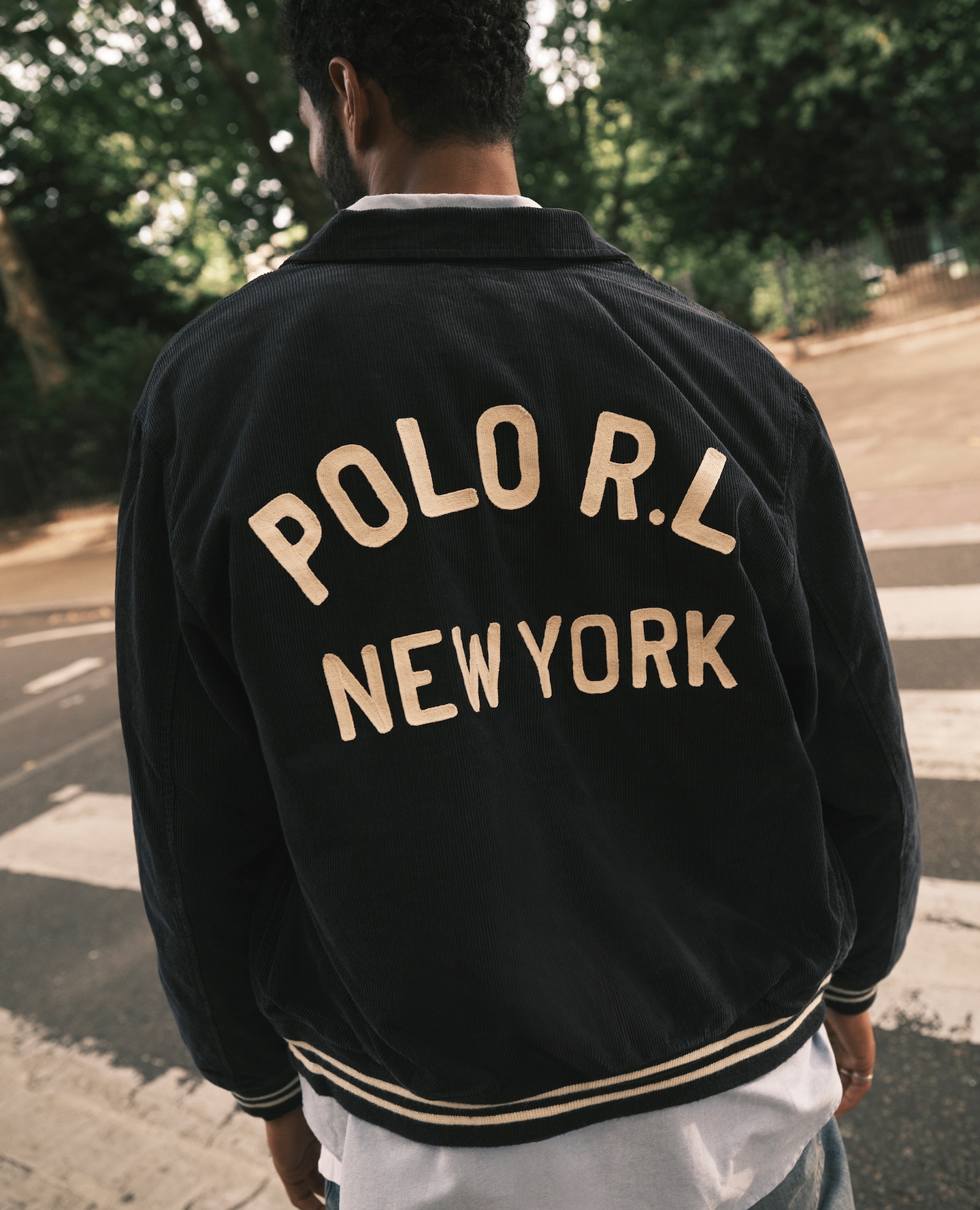 Model wears Polo Ralph Lauren Cord Varsity Jacket - Navy