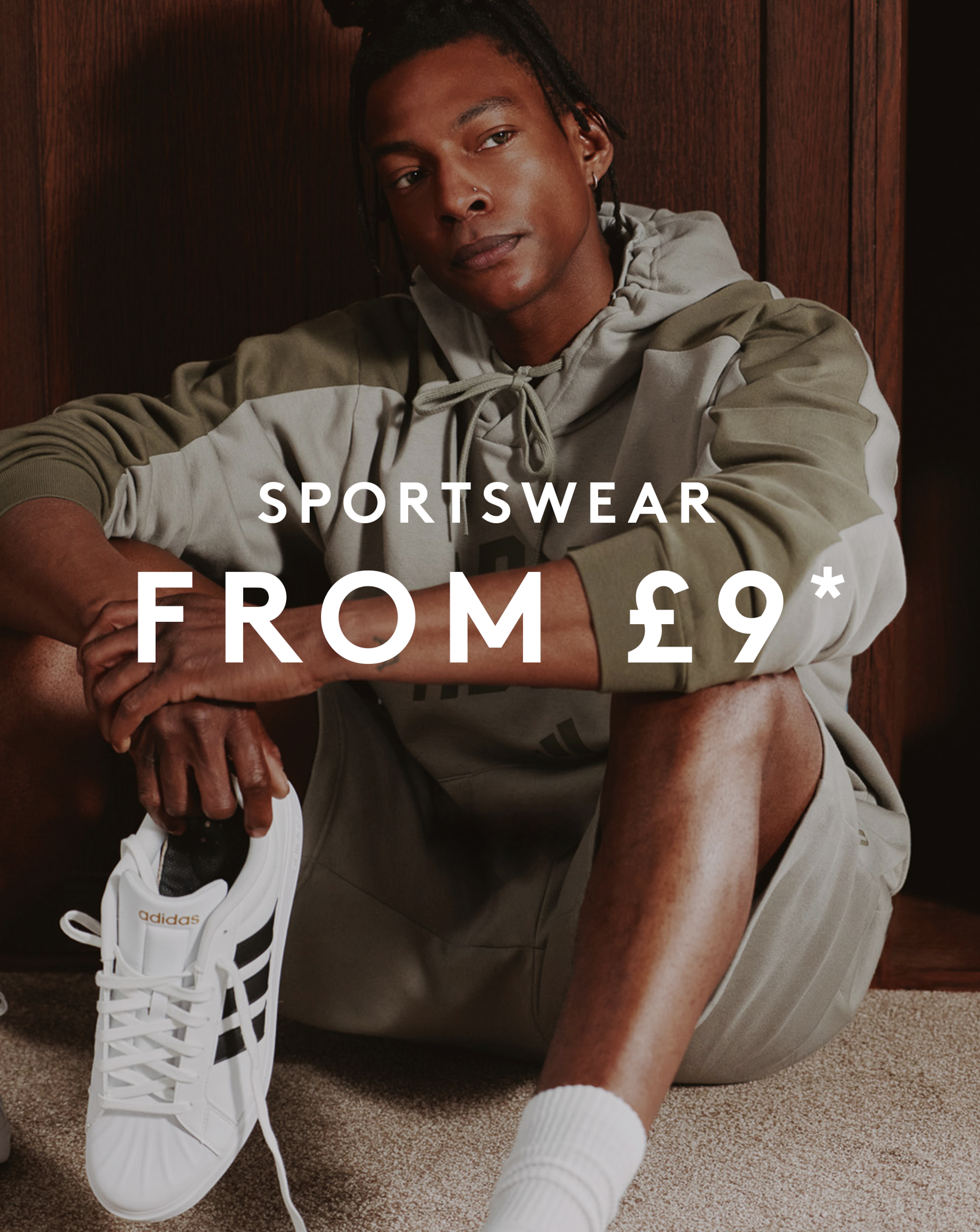 Model is wearing an adidas collegiate hoodie with matching shorts.