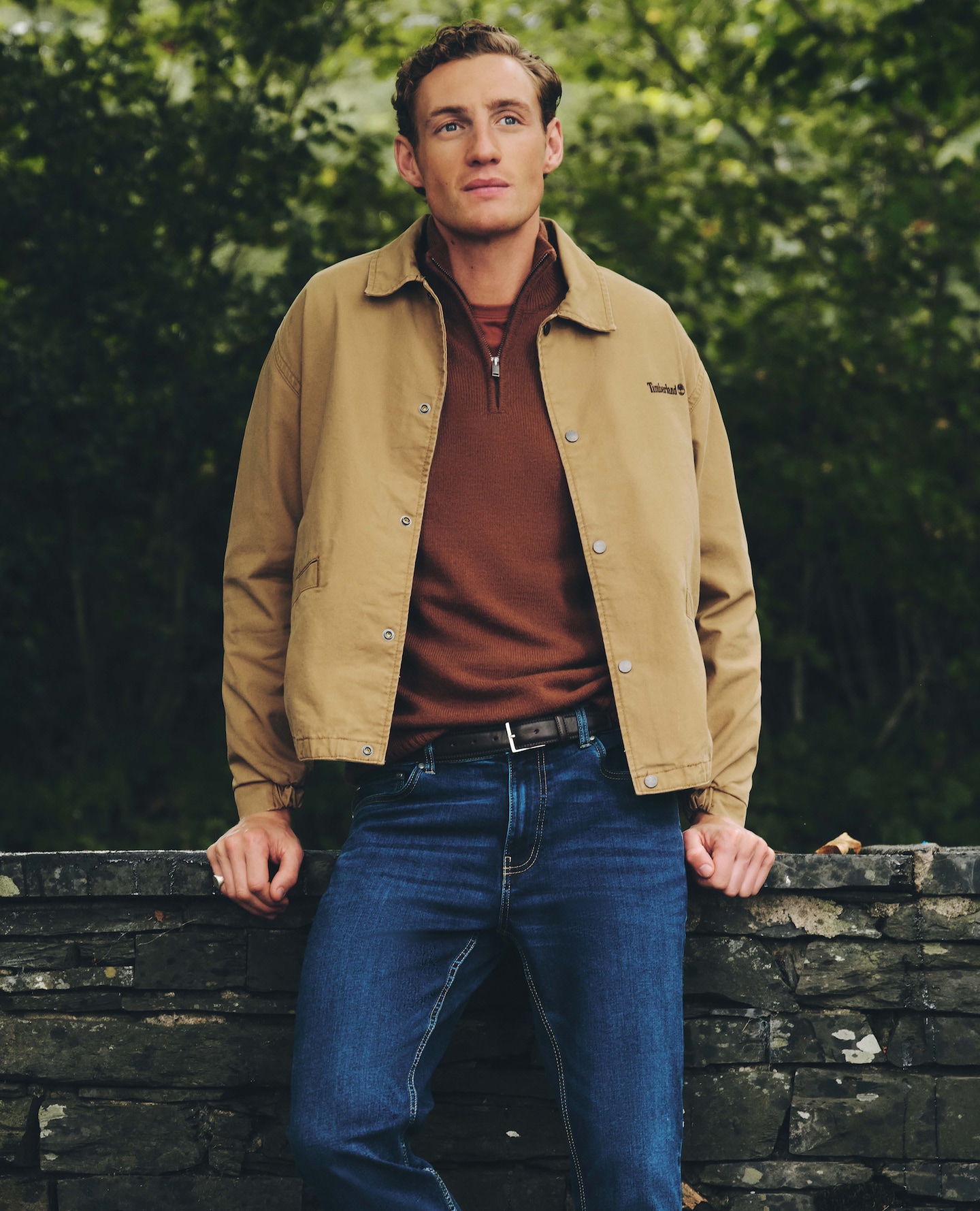 Modle wears Timberland Coach Jacket - Beige with casula Burgundy top