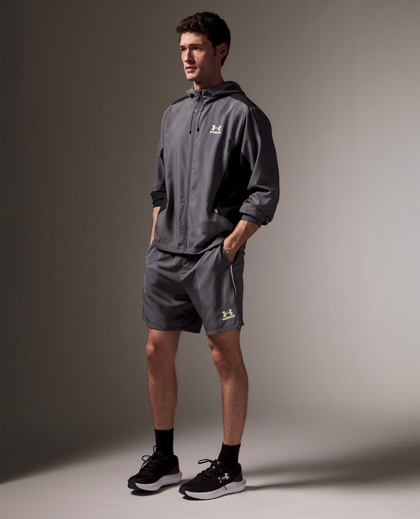 Model wears Under Armour trainer top and shorts