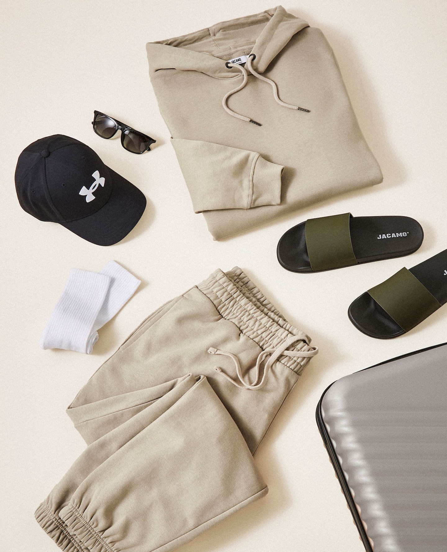 Image of various holiday items from slides, sunglasses and hats to suitcases