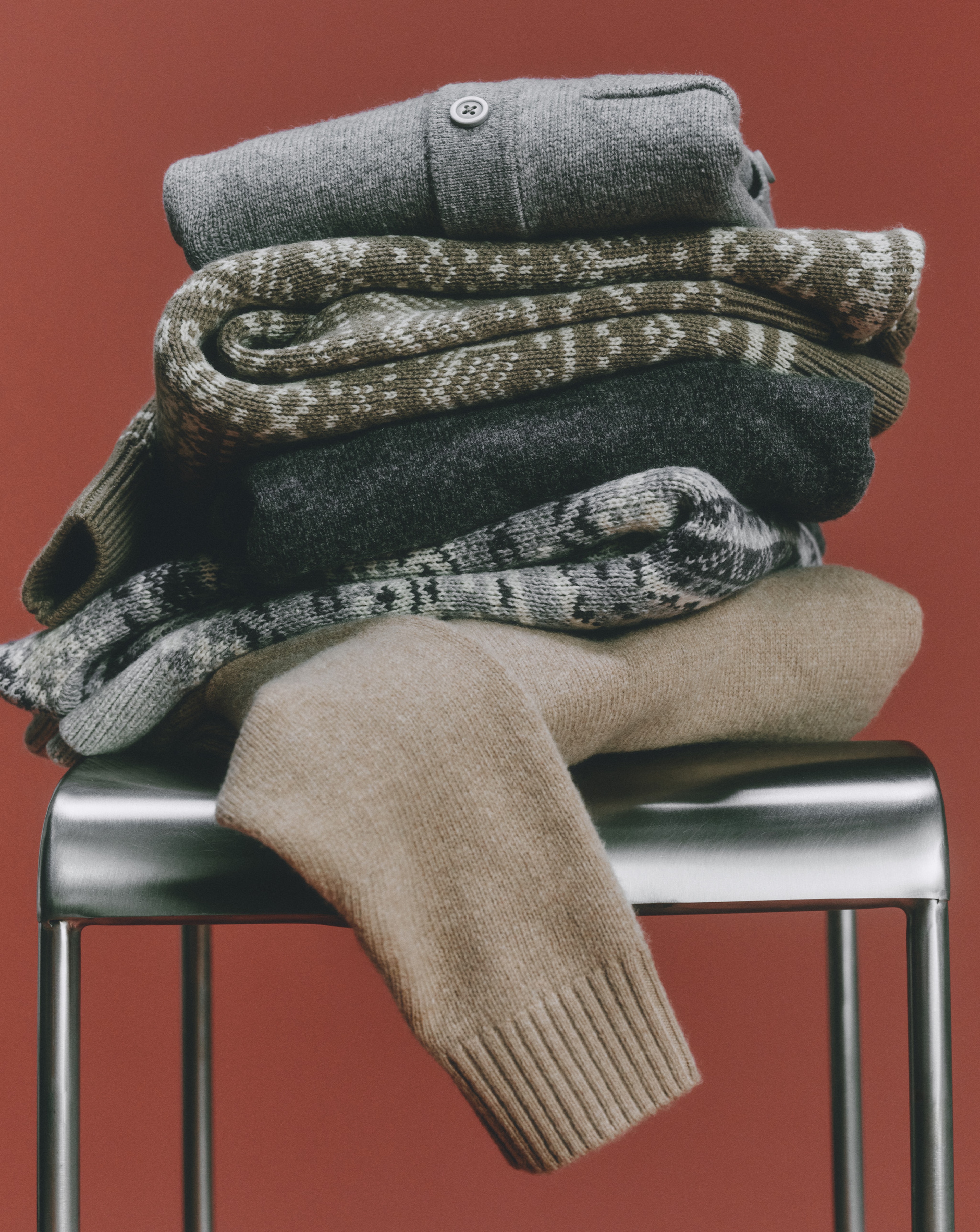 Folded pile of autumnal knitwear