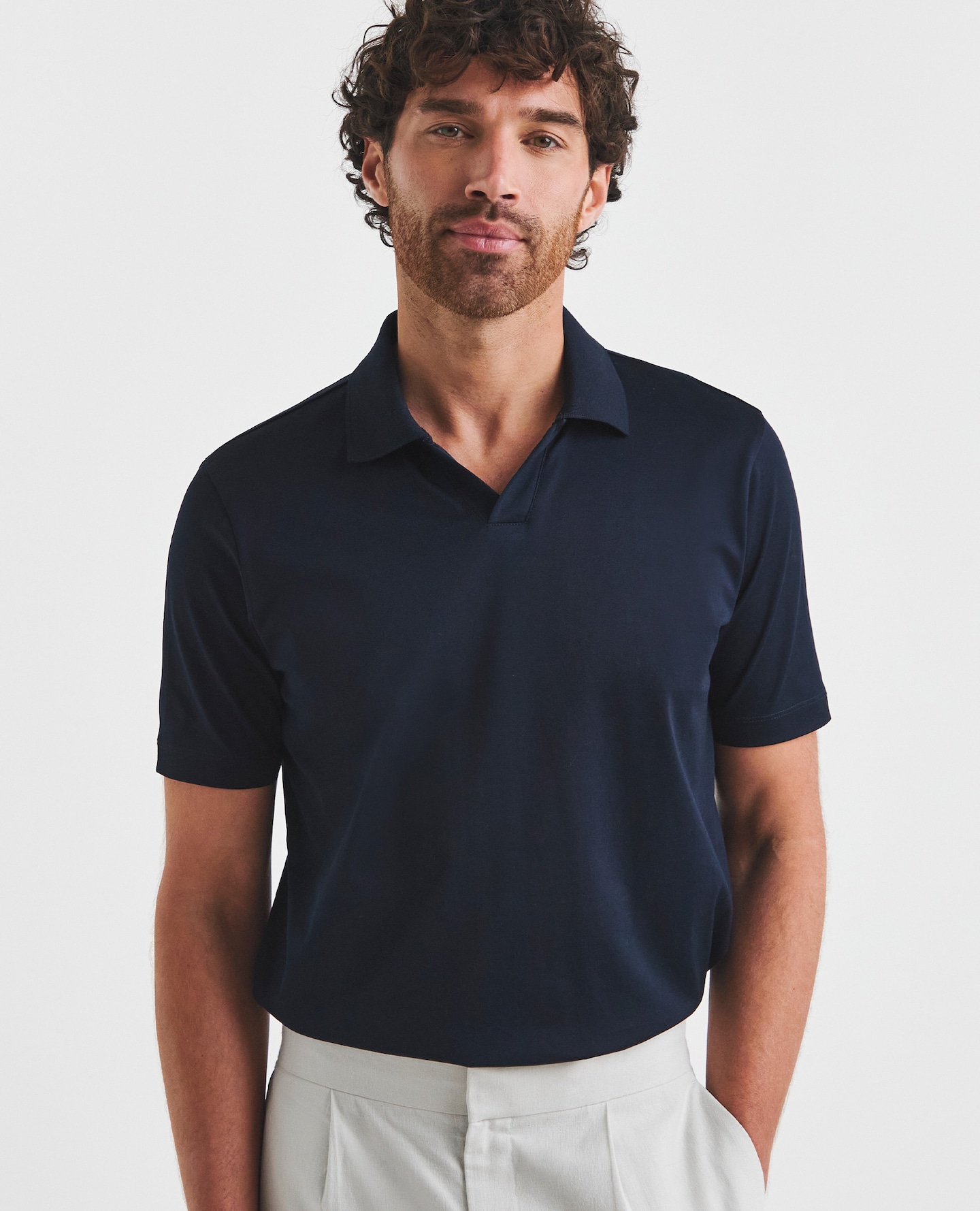 Model wearing navy blue polo