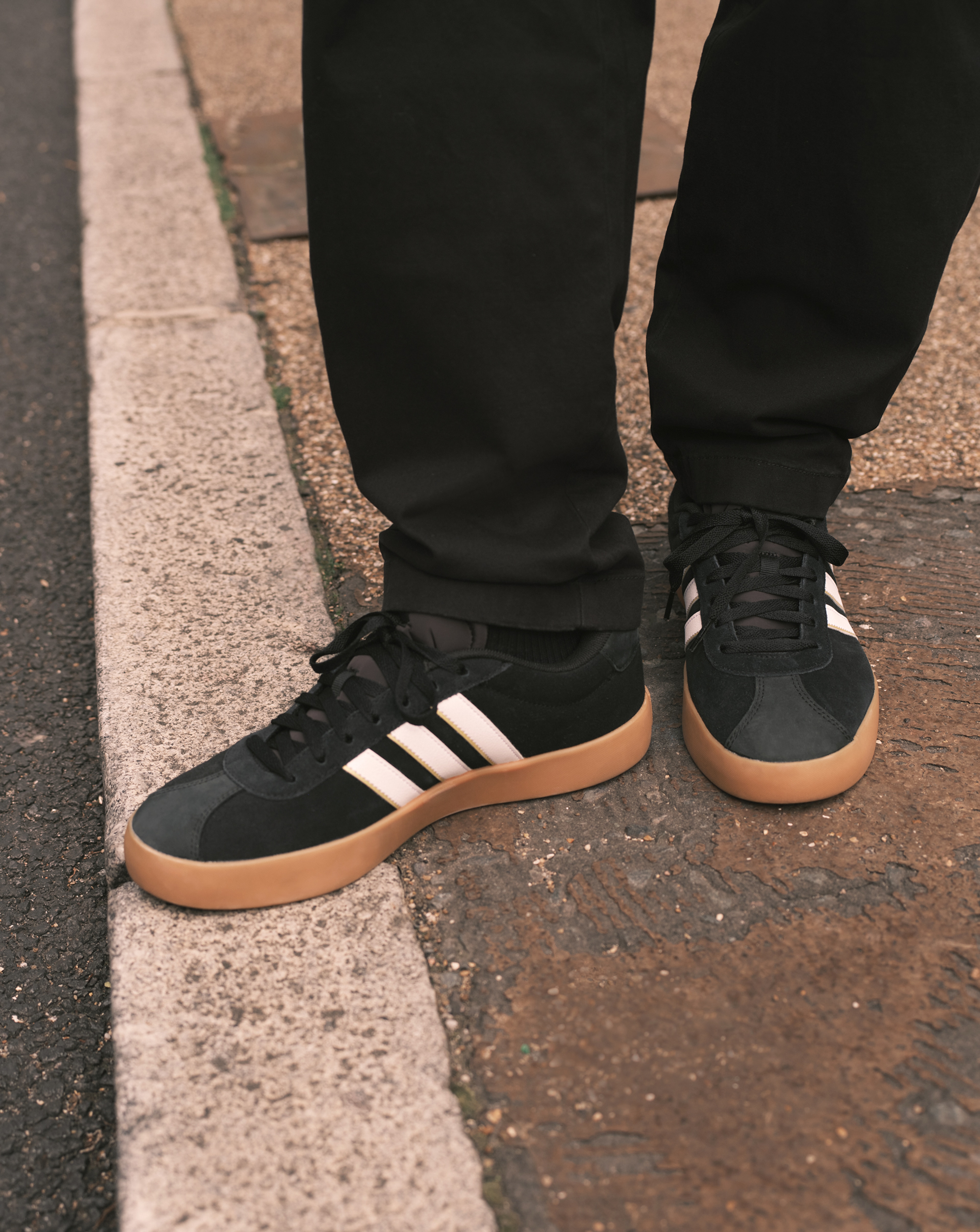 Model wears adidas VL Court 3.0 Trainers in Black/White