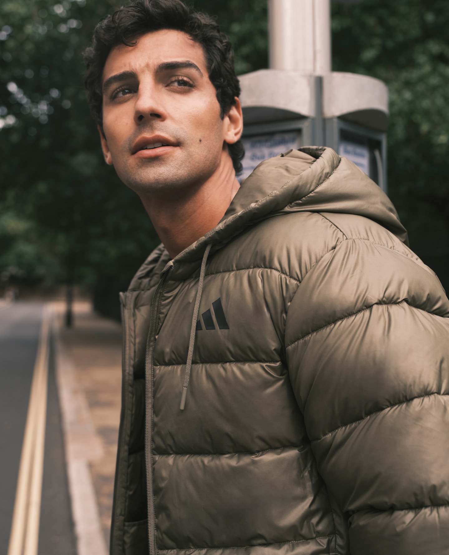 Model wearing khaki adidas parka