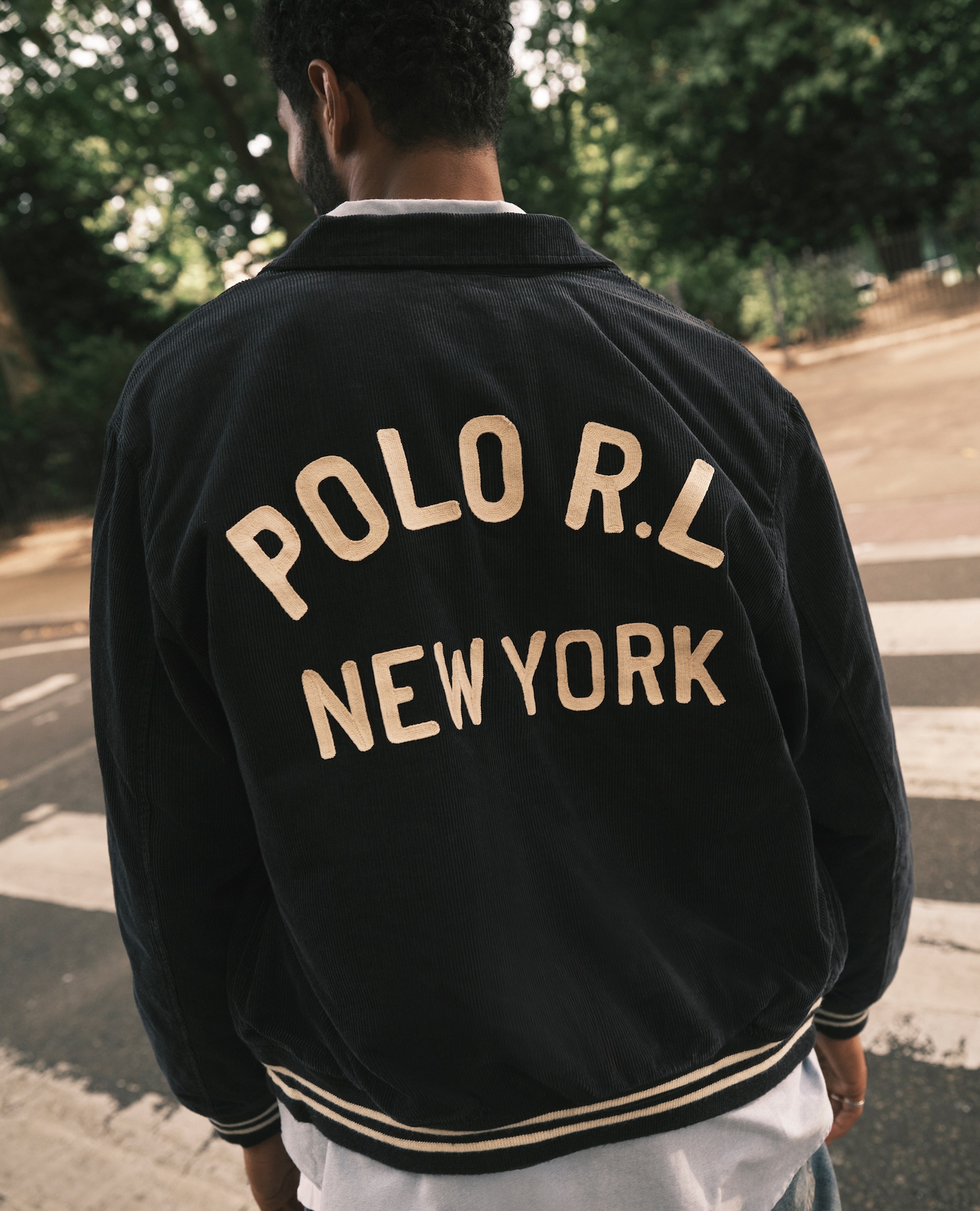 Model wears Polo Ralph Lauren Cord Varsity Jacket - Navy