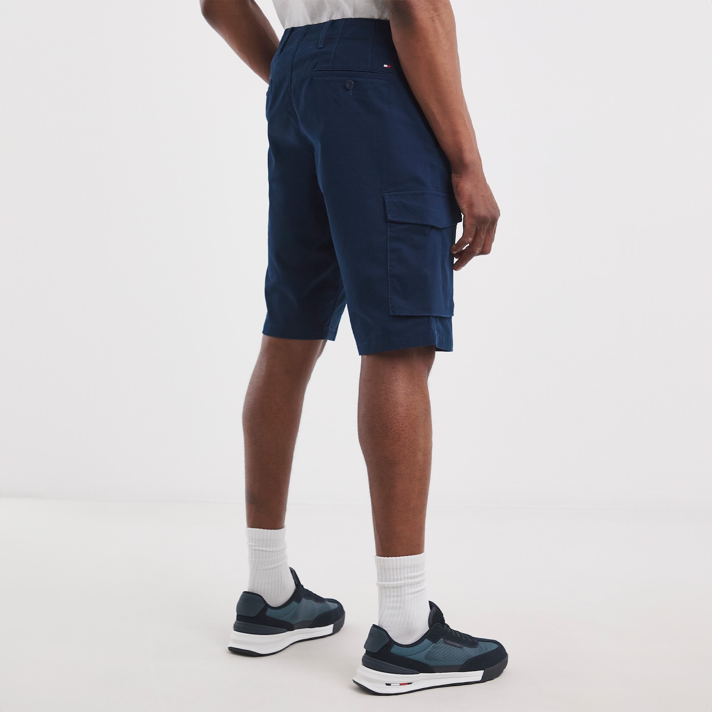 Model wearing blue Tommy Hilfiger shorts
