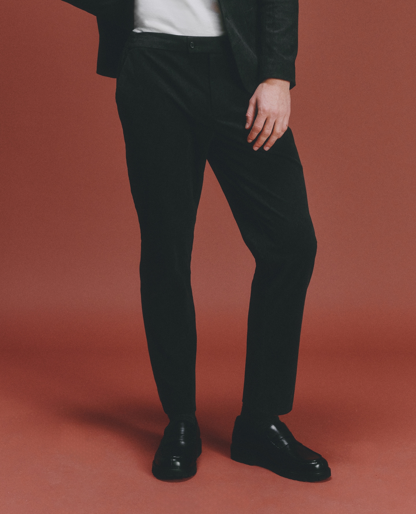 Model wears Regular Essential Suit Trousers in Black