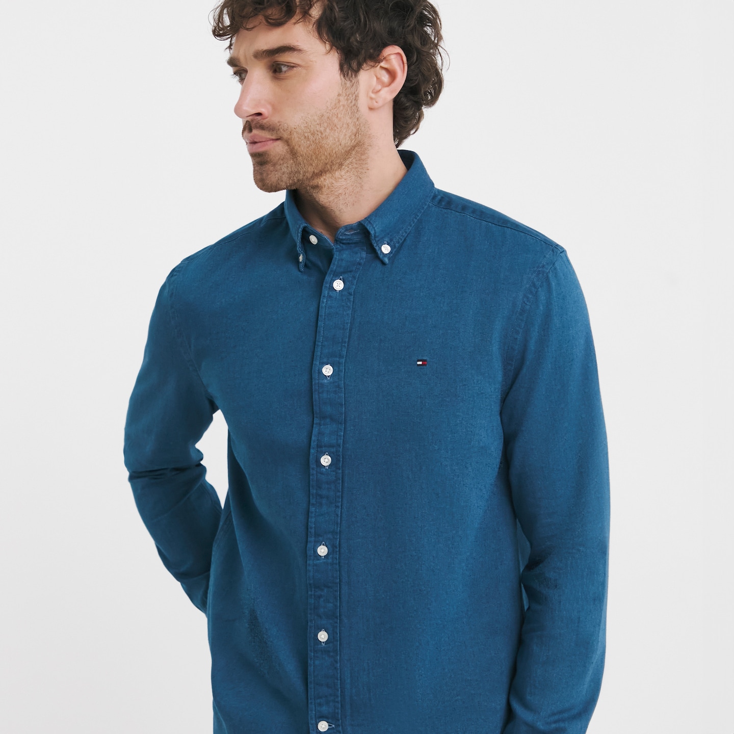 Model wearing a blue Tommy Hilfiger shirts