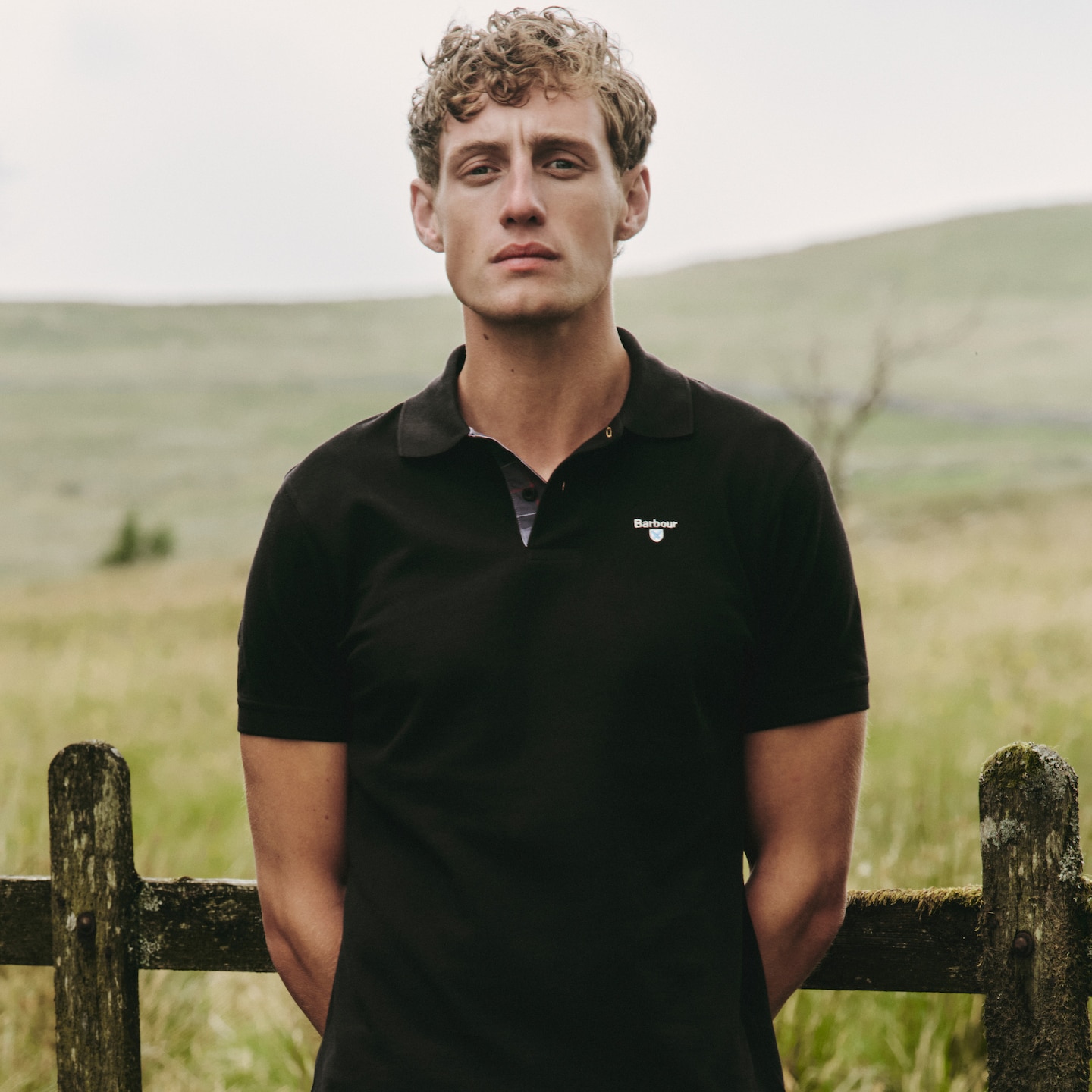Model wearing black Barbour polo