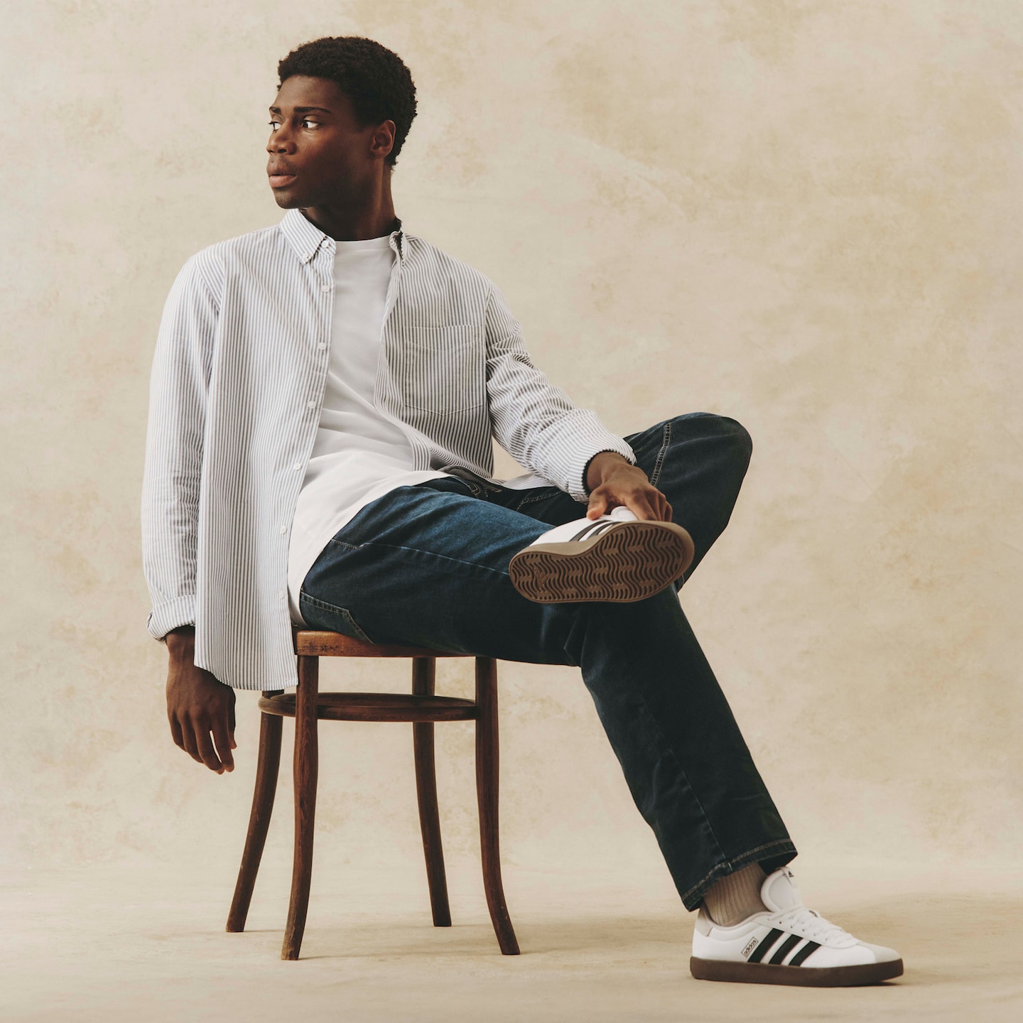 Model wears Stripe Oxford Shirt Long with white t-shirt, jeans and adidas VL Court 3.0 Trainers