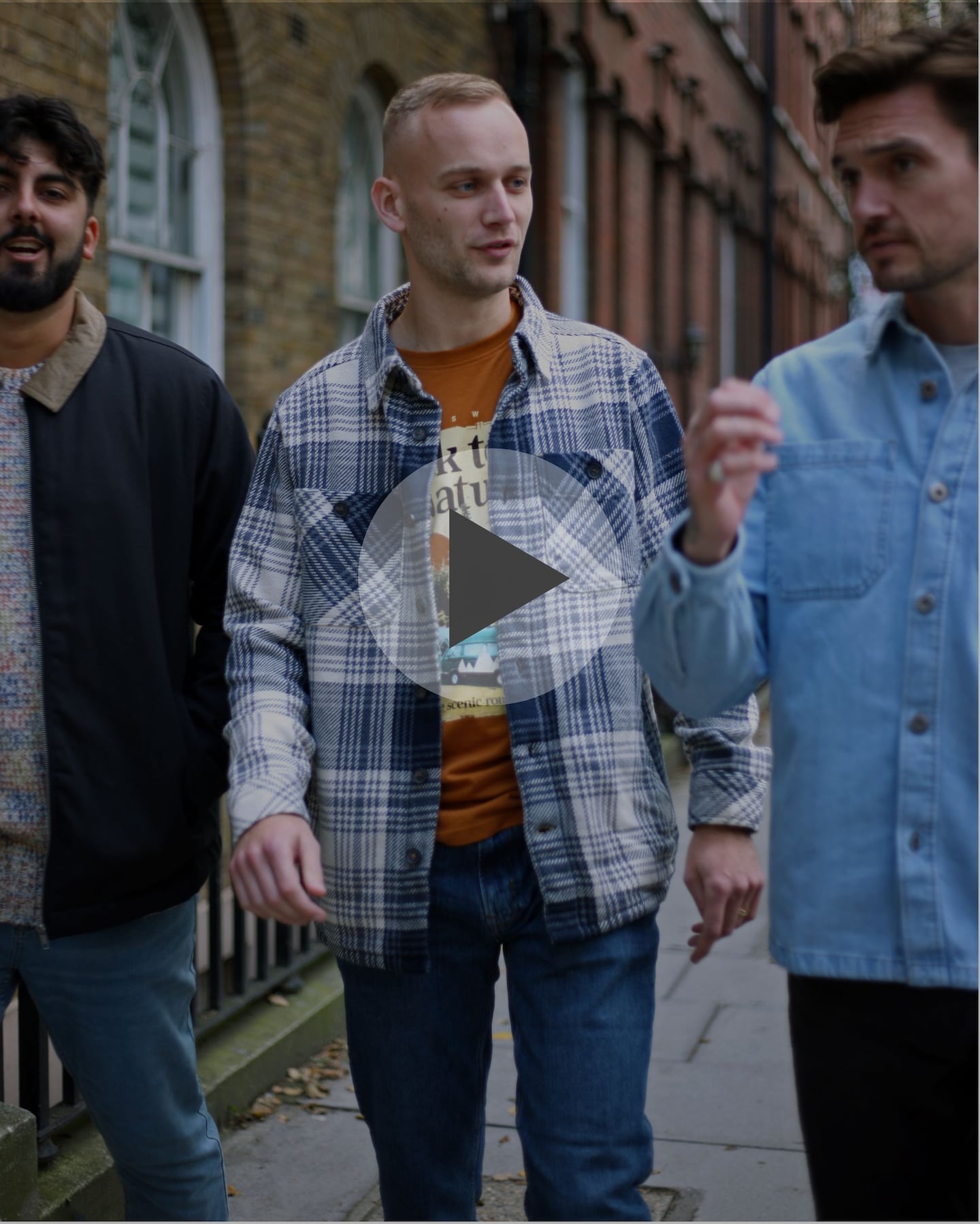 A video still of 3 men walking