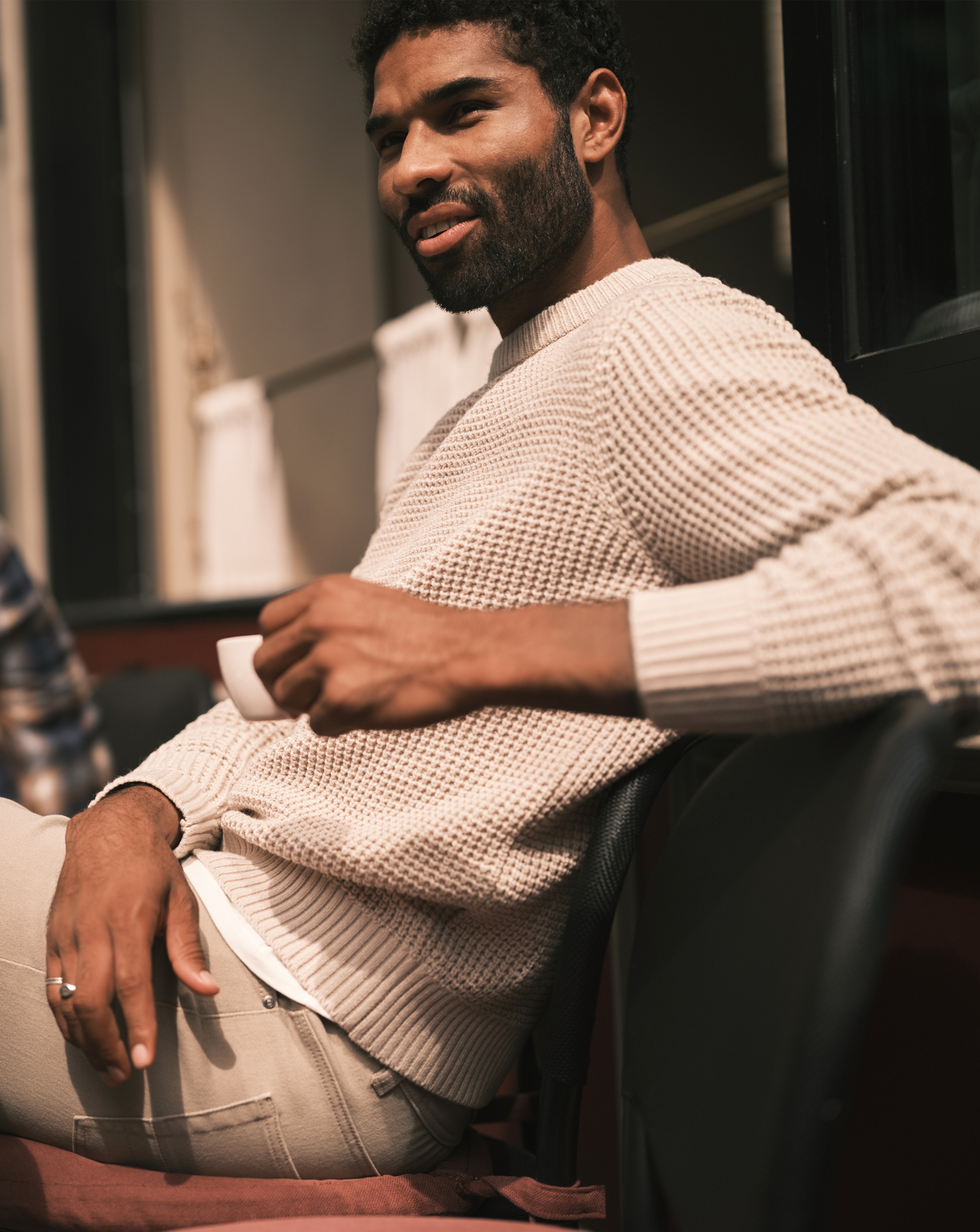 Model wears Cream Crew Neck Jumper