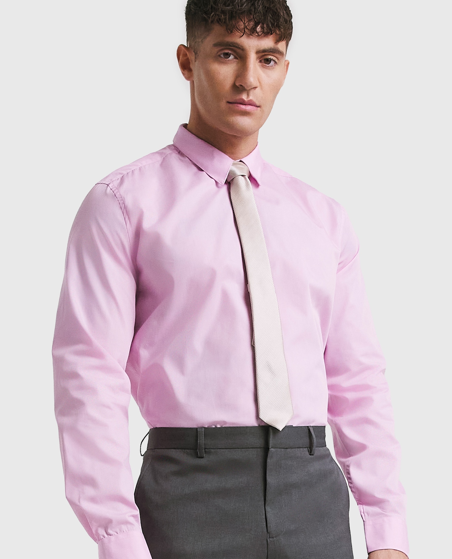 Model wearing pink shirt and white tie
