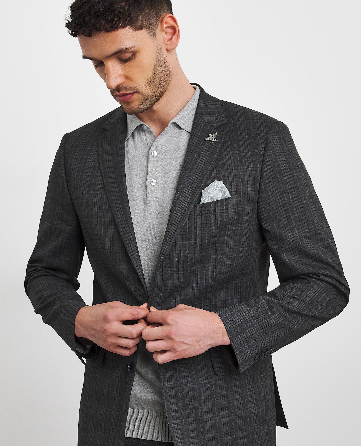 Model wears grey polo with smart jacket