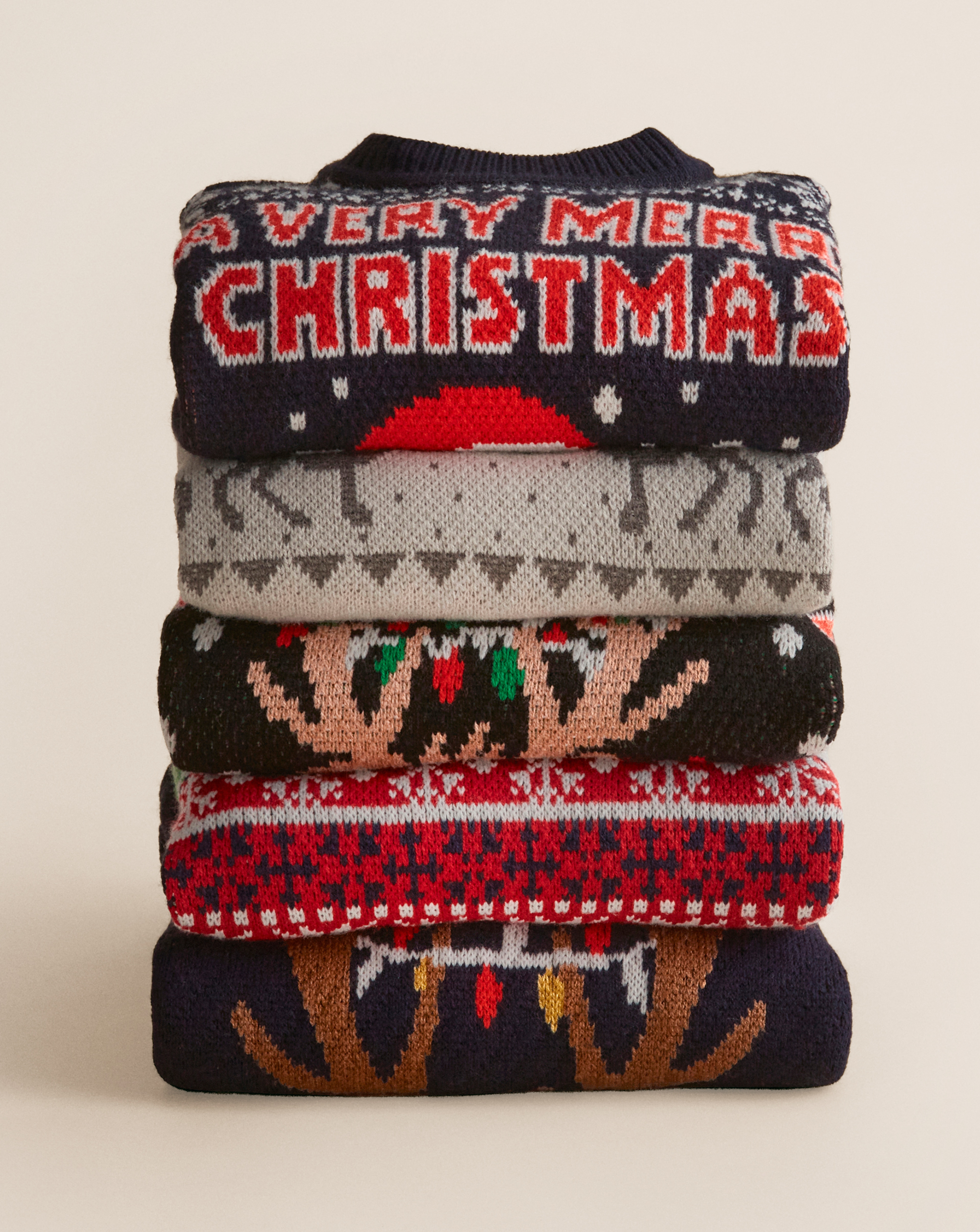 Christmas jumpers including Tree-rex Christmas Jumper and Christmas Novelty Reinbeer Jumper are pictured.