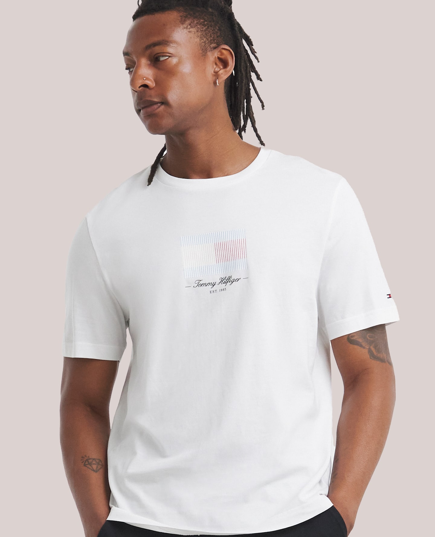 Model wearing a white Tommy Hilfiger t-shirt