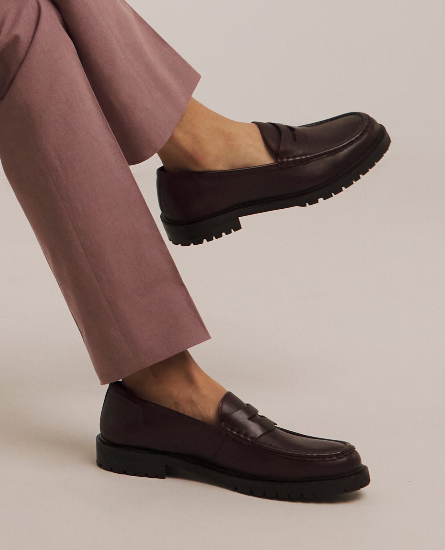 Model wearing smart brown loafers