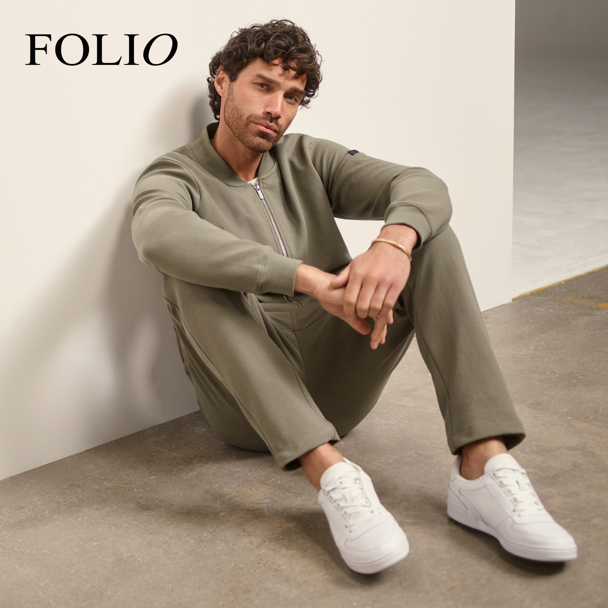 Folio. Model wears Folio Twill Bomber with Folio Cotton Stretch Jogger in Khaki