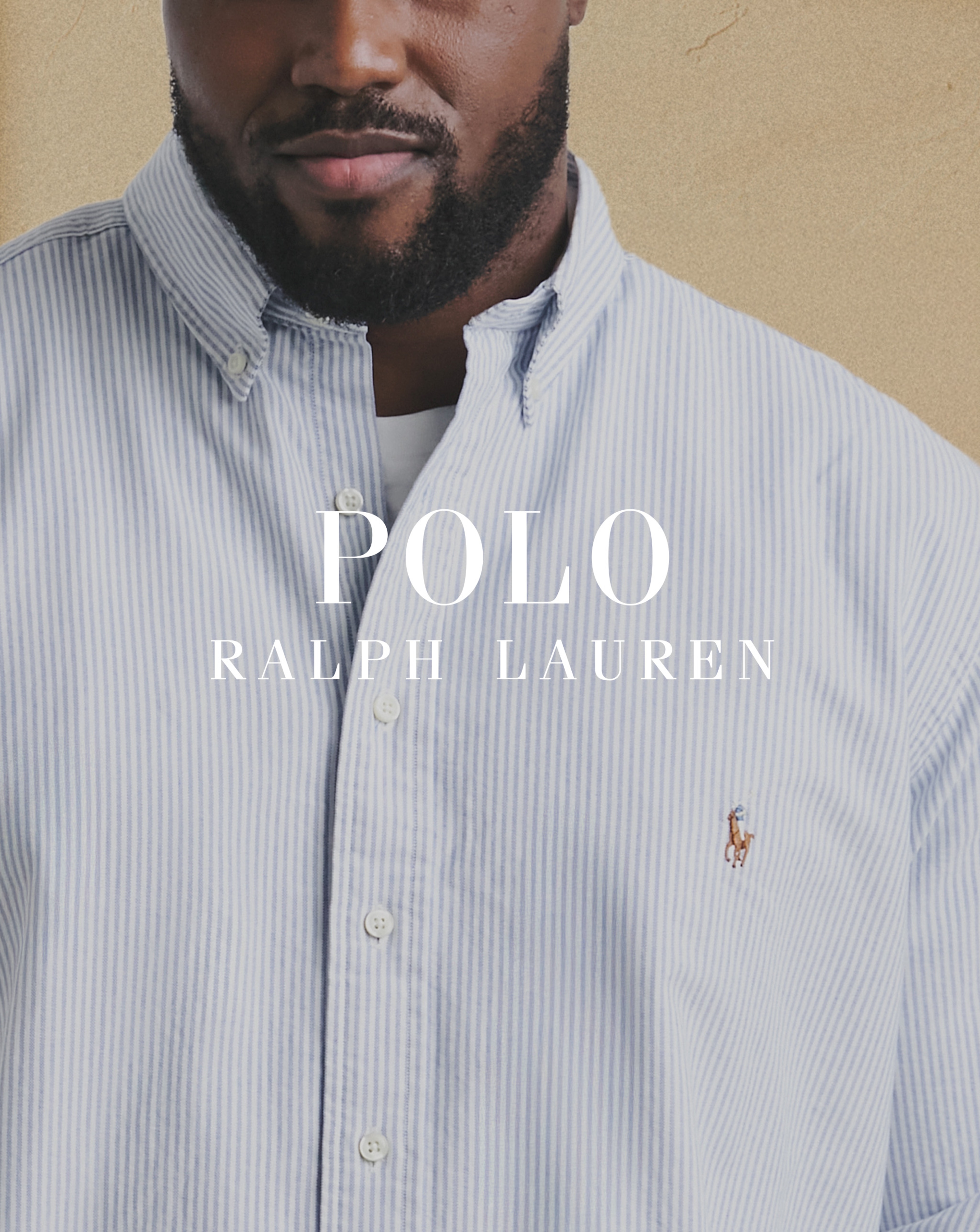 Polo Ralph Lauren. Model wears Polo Ralph Lauren Long Sleeve Chambray Stretch Pique Shirt - Blue