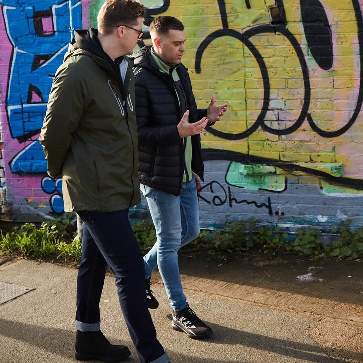 2 men walking and chatting