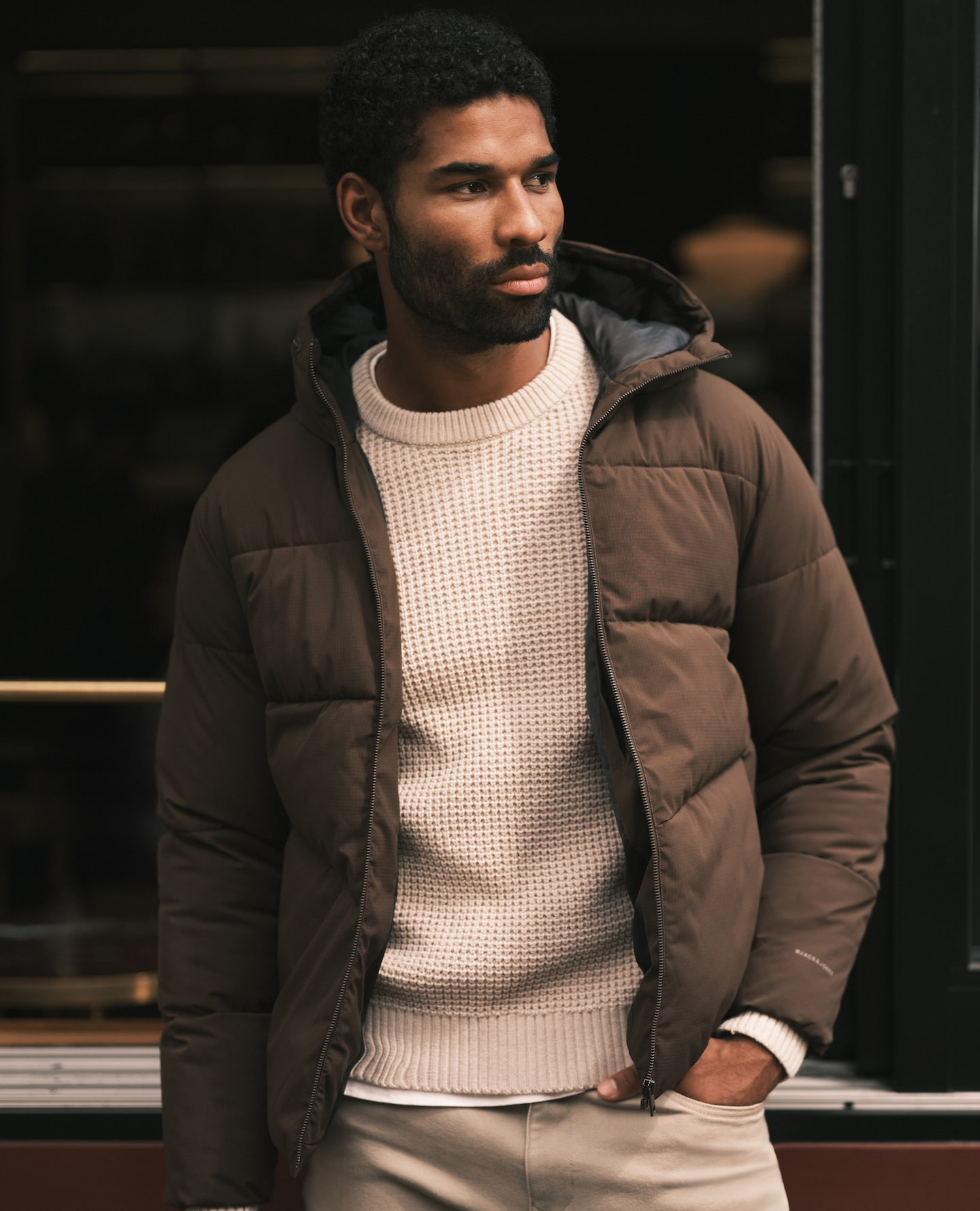 Model wearing a khaki Jack & Jones puffer jacket